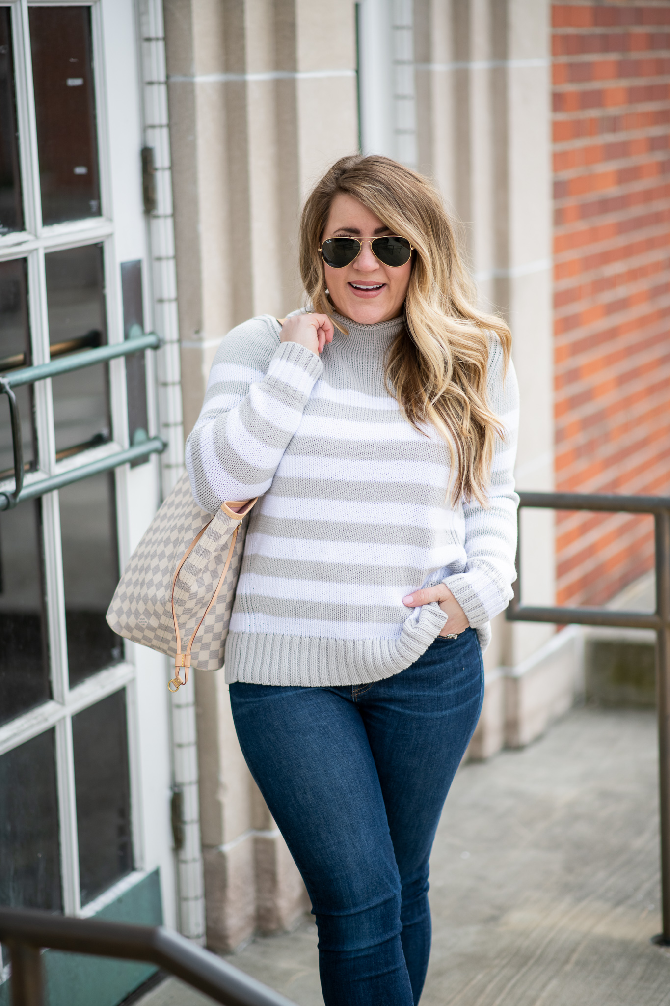 J.Crew Jeans Featured by top US fashion blog Coffee Beans and Bobby Pins; Image of a woman wearing J.Crew jeans, Ray Ban sunglasses, J.Crew sweater, DSW shoes and Sugarfix earrings from Target.