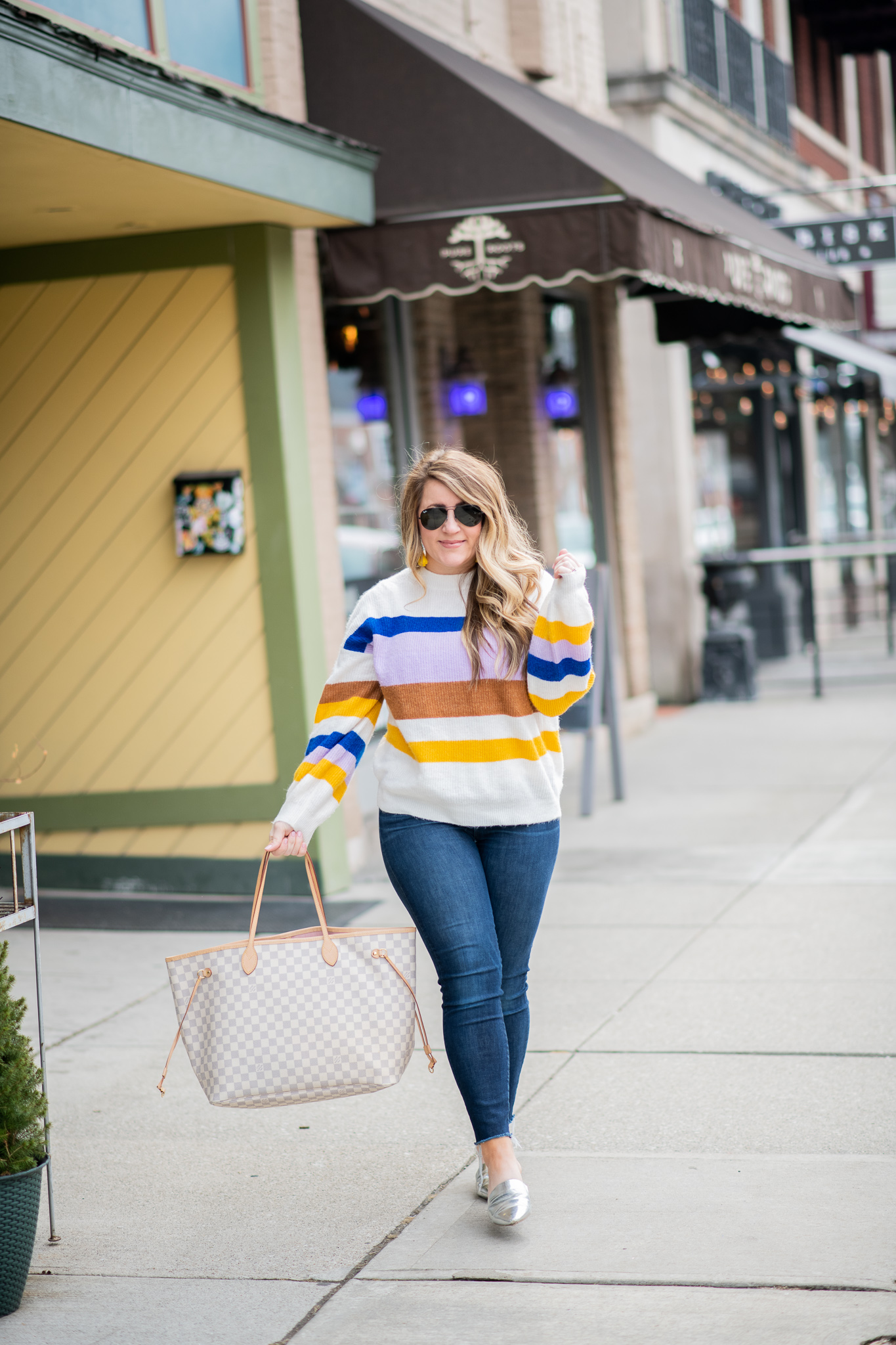Striped Sweater featured by top US fashion blog Coffee Beans and Bobby Pins; Image of a woman wearing Express striped sweater, J.Crew jeans, DSW mules, Amazon sunglasses, Sugarfix earrings and Louis Vuitton bag.