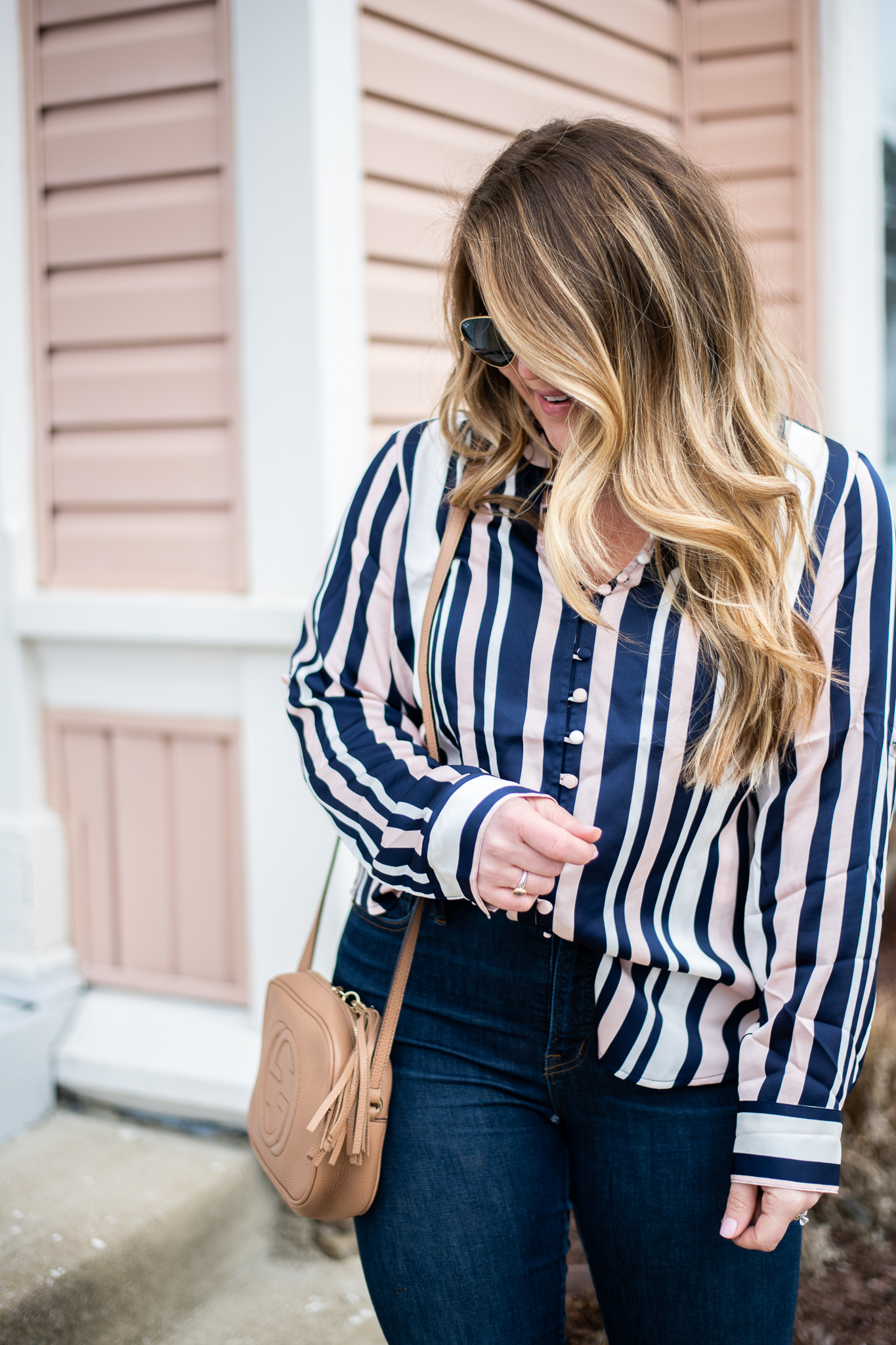 Striped Blush Blouse featured by top US fashion blog, Coffee Beans and Bobby Pins; image of woman wearing an express striped blouse, J.crew jeans, louis vuitton bag, target earrings and Nordstrom shoes