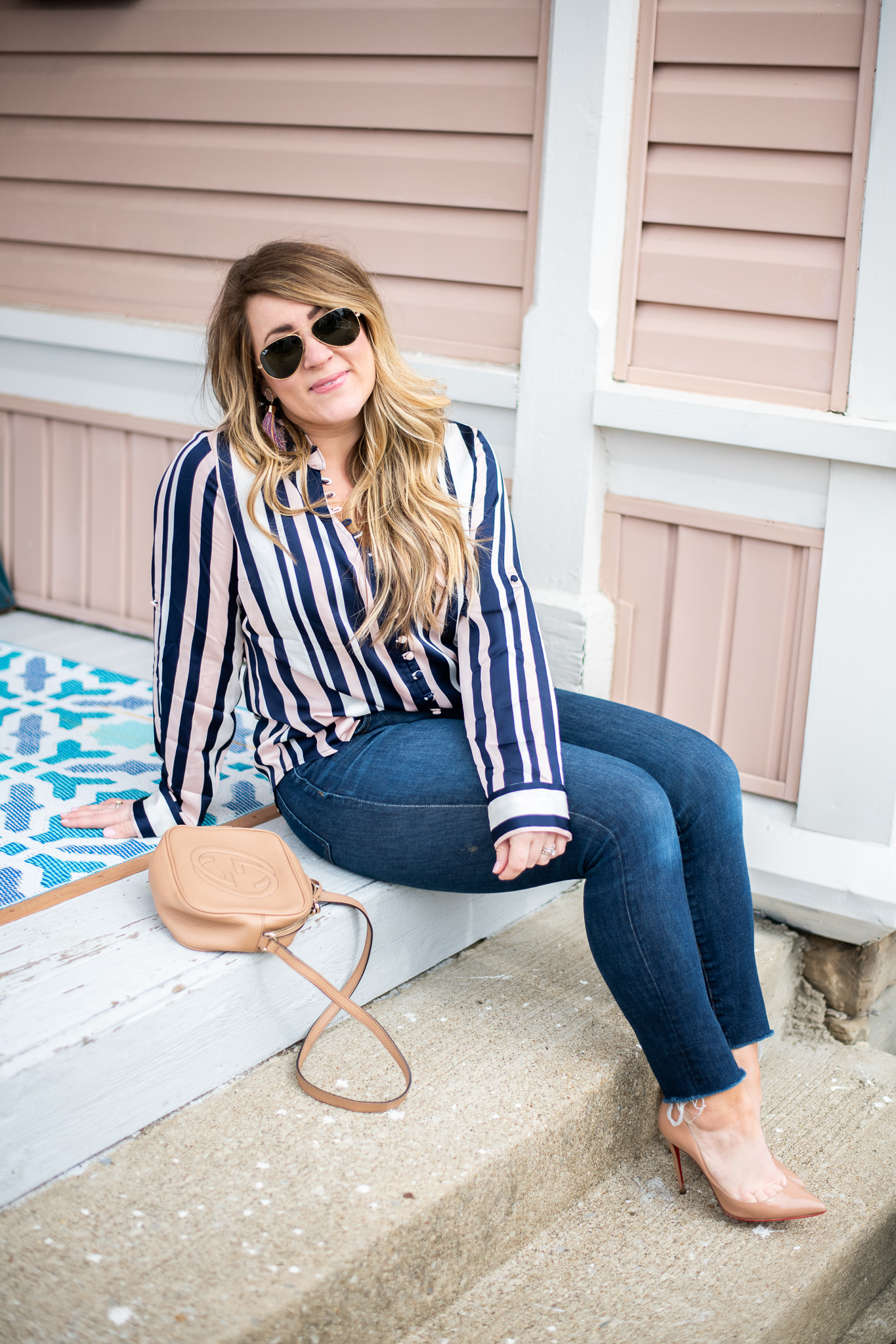 Striped Blush Blouse featured by top US fashion blog, Coffee Beans and Bobby Pins; image of woman wearing an express striped blouse, J.crew jeans, louis vuitton bag, target earrings and Nordstrom shoes