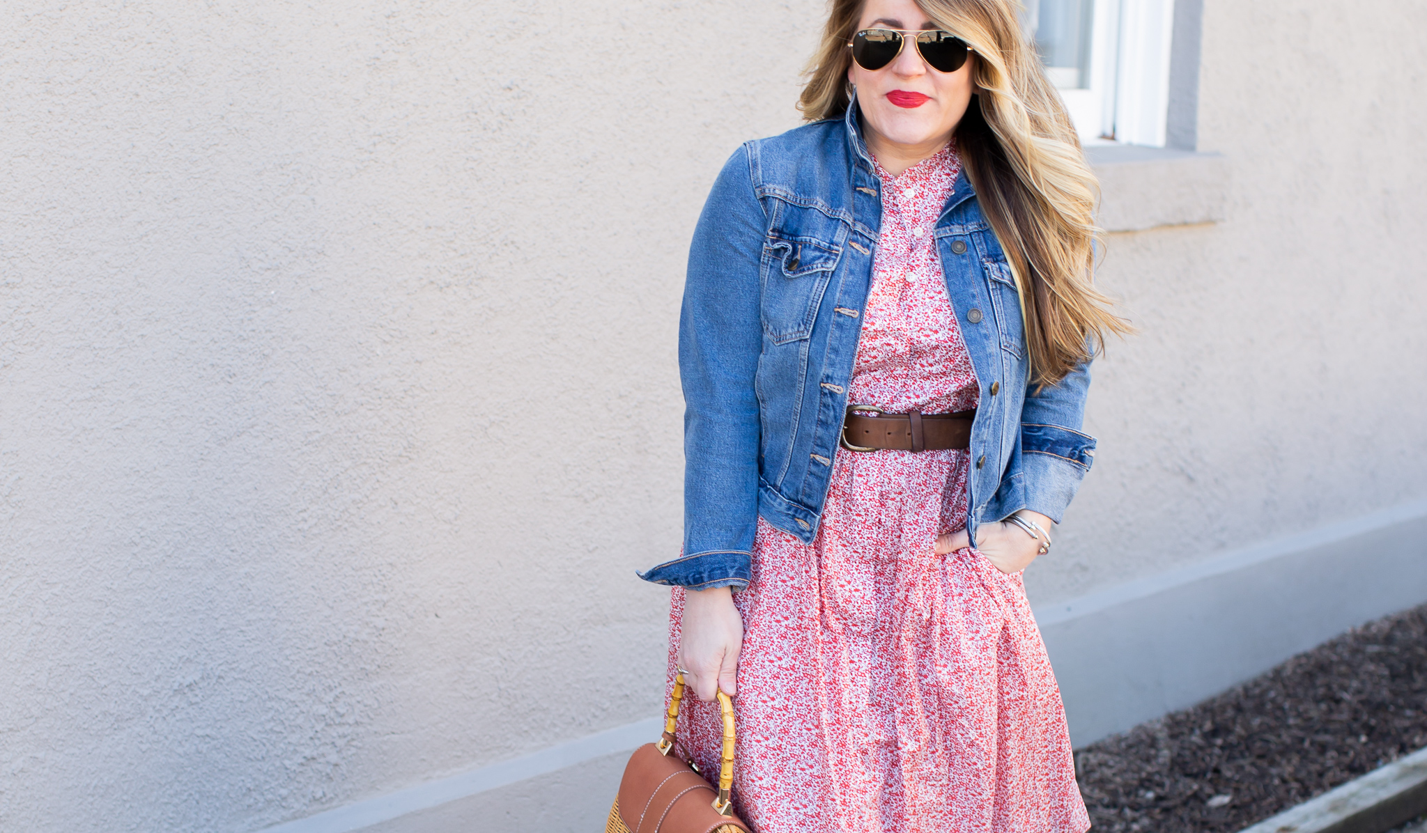 Sneakers with Dress featured by top US fashion blog Coffee Beans and Bobby Pins; Image of a woman wearing a floral dress, Nordstrom sneakers and Madewell denim jacket.