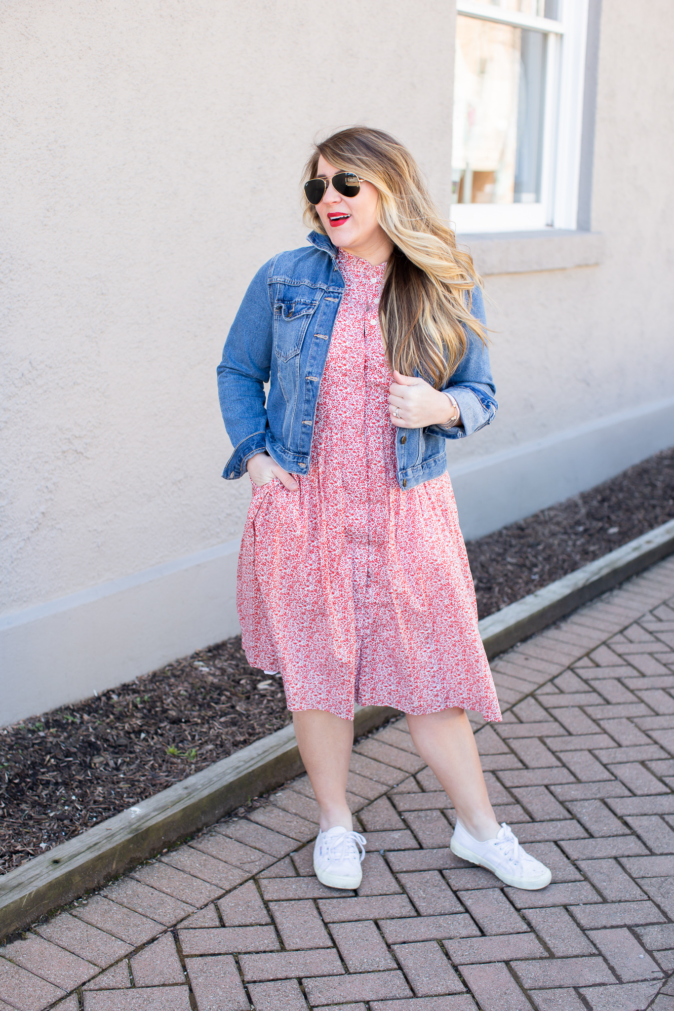Sneakers with Dress featured by top US fashion blog Coffee Beans and Bobby Pins; Image of a woman wearing a floral dress, Nordstrom sneakers and Madewell denim jacket.