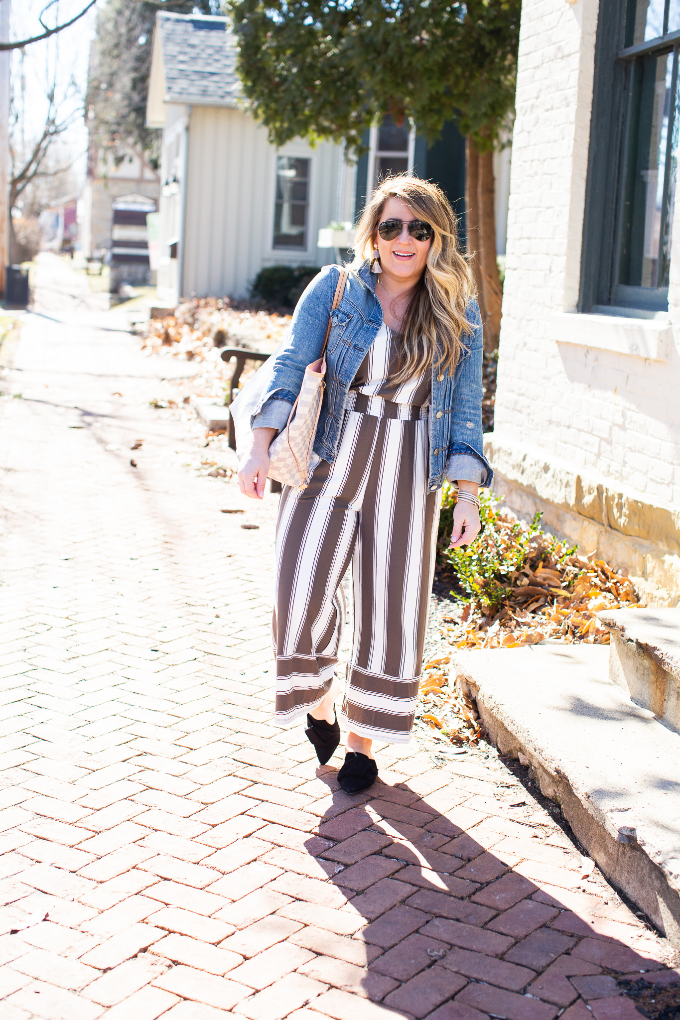 Olive Green Jumpsuit featured by top US curvy fashion blog Coffee Beans and Bobby Pins; Image of a woman wearing Express jumpsuit, Madewell jacket and J.Crew shoes.