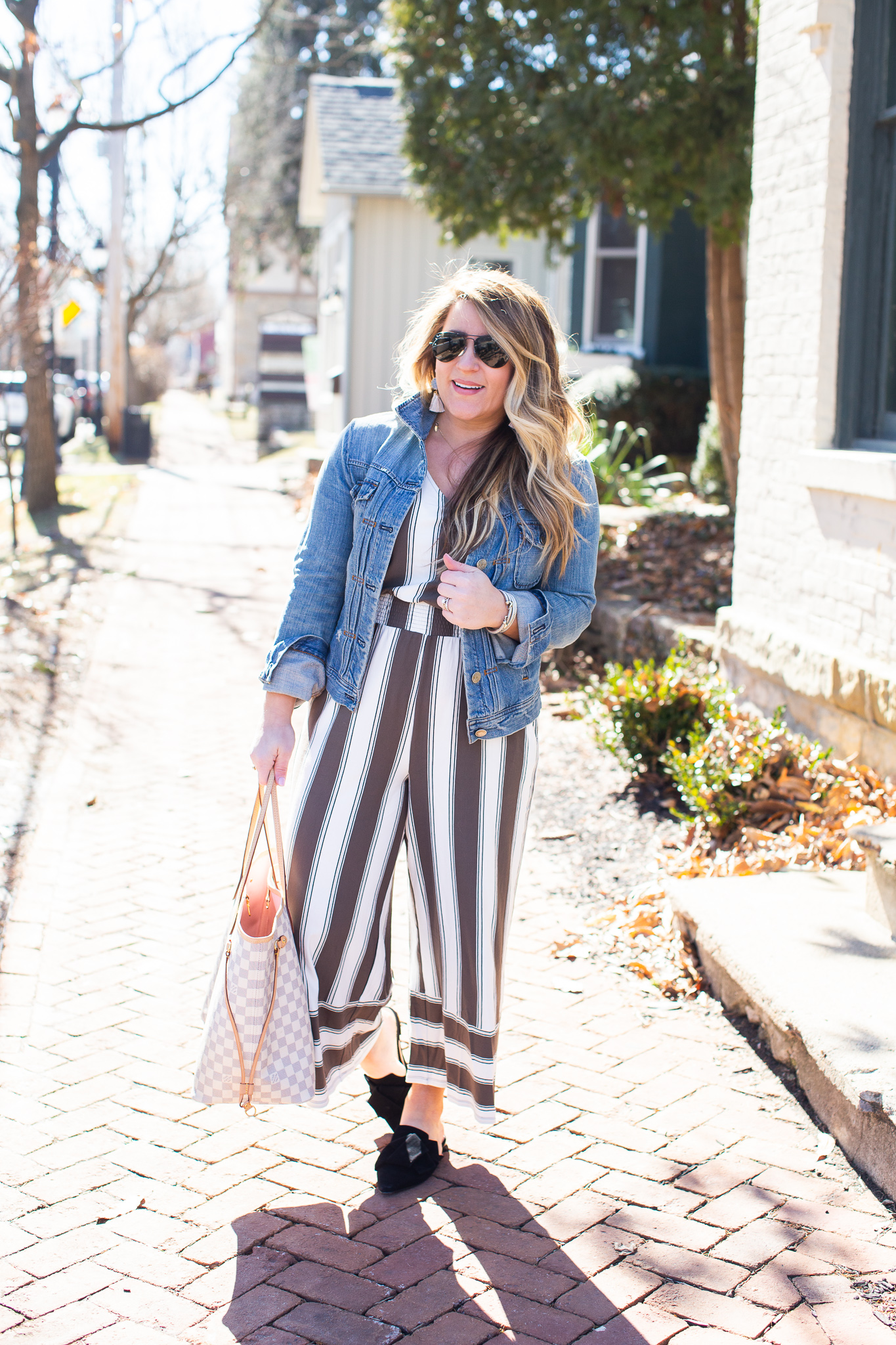 Olive Green Jumpsuit featured by top US curvy fashion blog Coffee Beans and Bobby Pins; Image of a woman wearing Express jumpsuit, Madewell jacket and J.Crew shoes.