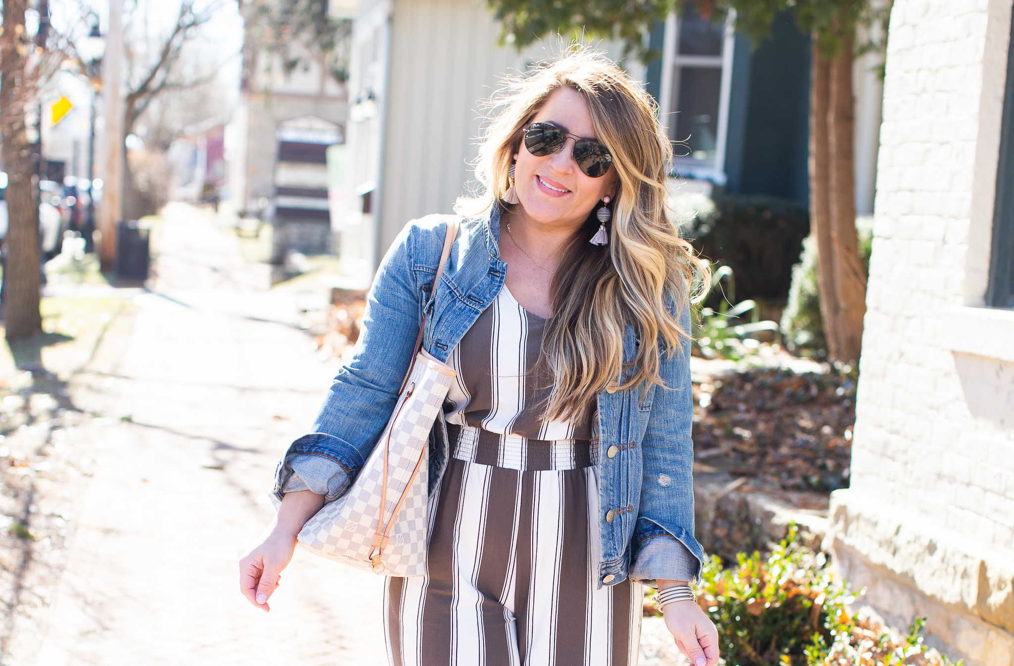 Olive Green Jumpsuit featured by top US curvy fashion blog Coffee Beans and Bobby Pins; Image of a woman wearing Express jumpsuit, Madewell jacket and J.Crew shoes.