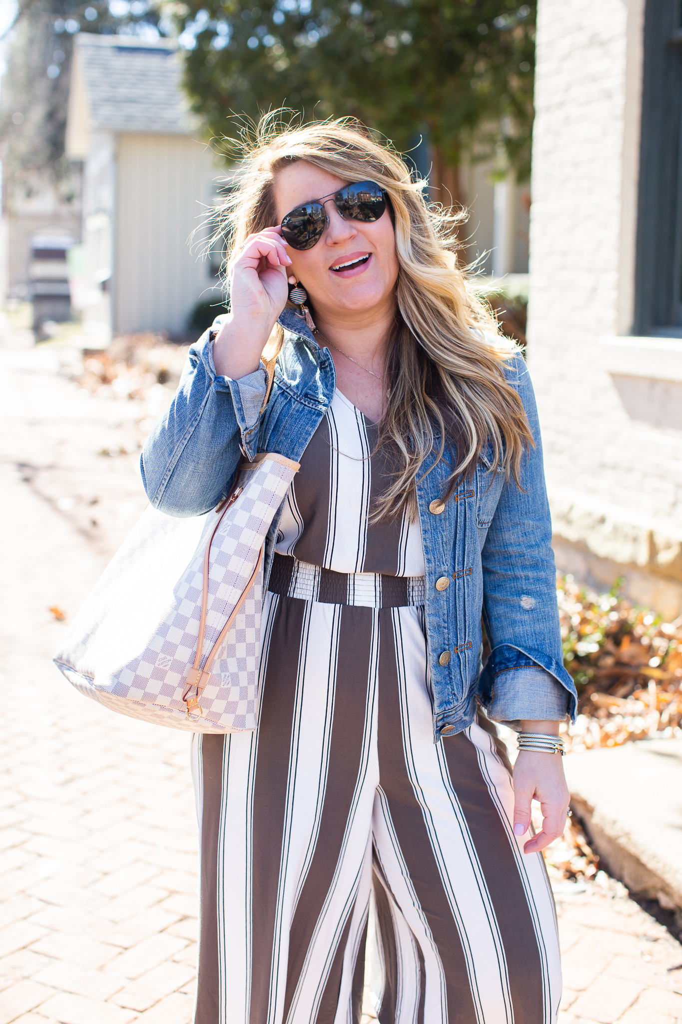 Olive Green Jumpsuit featured by top US curvy fashion blog Coffee Beans and Bobby Pins; Image of a woman wearing Express jumpsuit, Madewell jacket and J.Crew shoes.