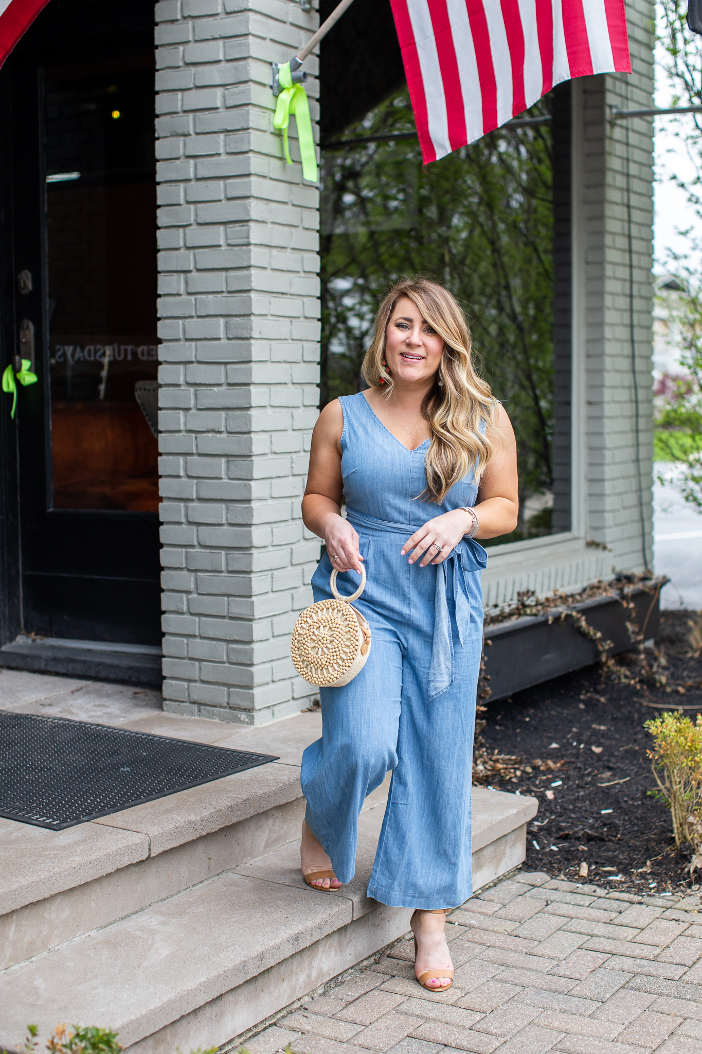 J.Crew Chambray Jumpsuit featured by top US fashion blog Coffee Beans and Bobby Pins; Image of a woman wearing a J.Crew jumpsuit, Steve Madden sandals, Target bag and Baublebar earrings.
