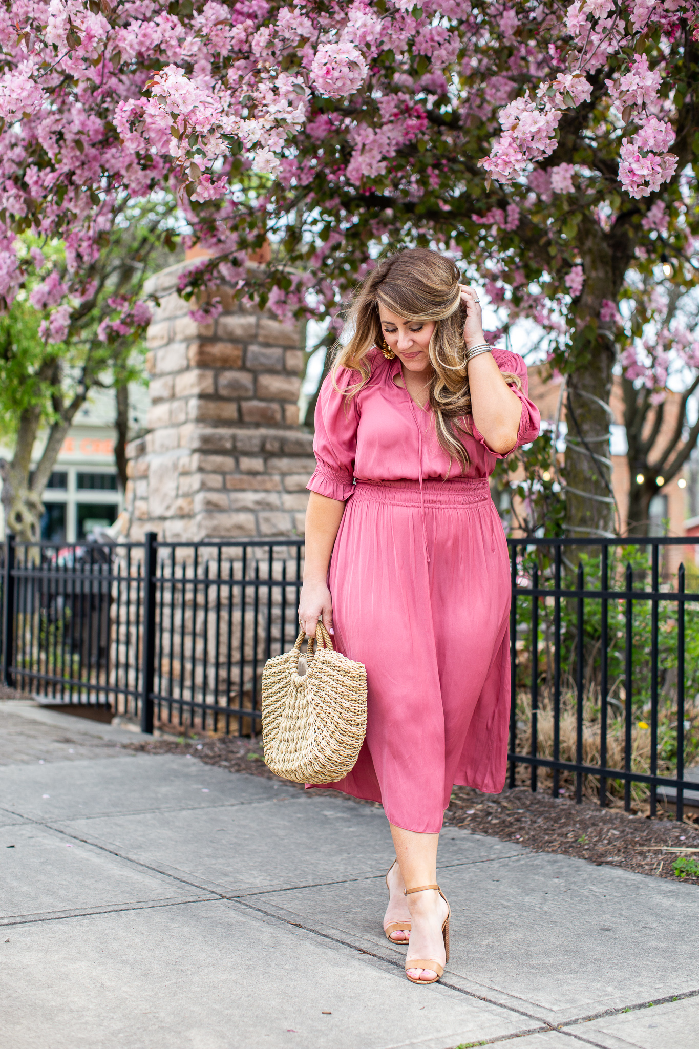 Pink Midi Dress featured by top US fashion blog Coffee Beans and Bobby Pins; Image of  a woman wearing pink Anthropologie dress and nude heels.