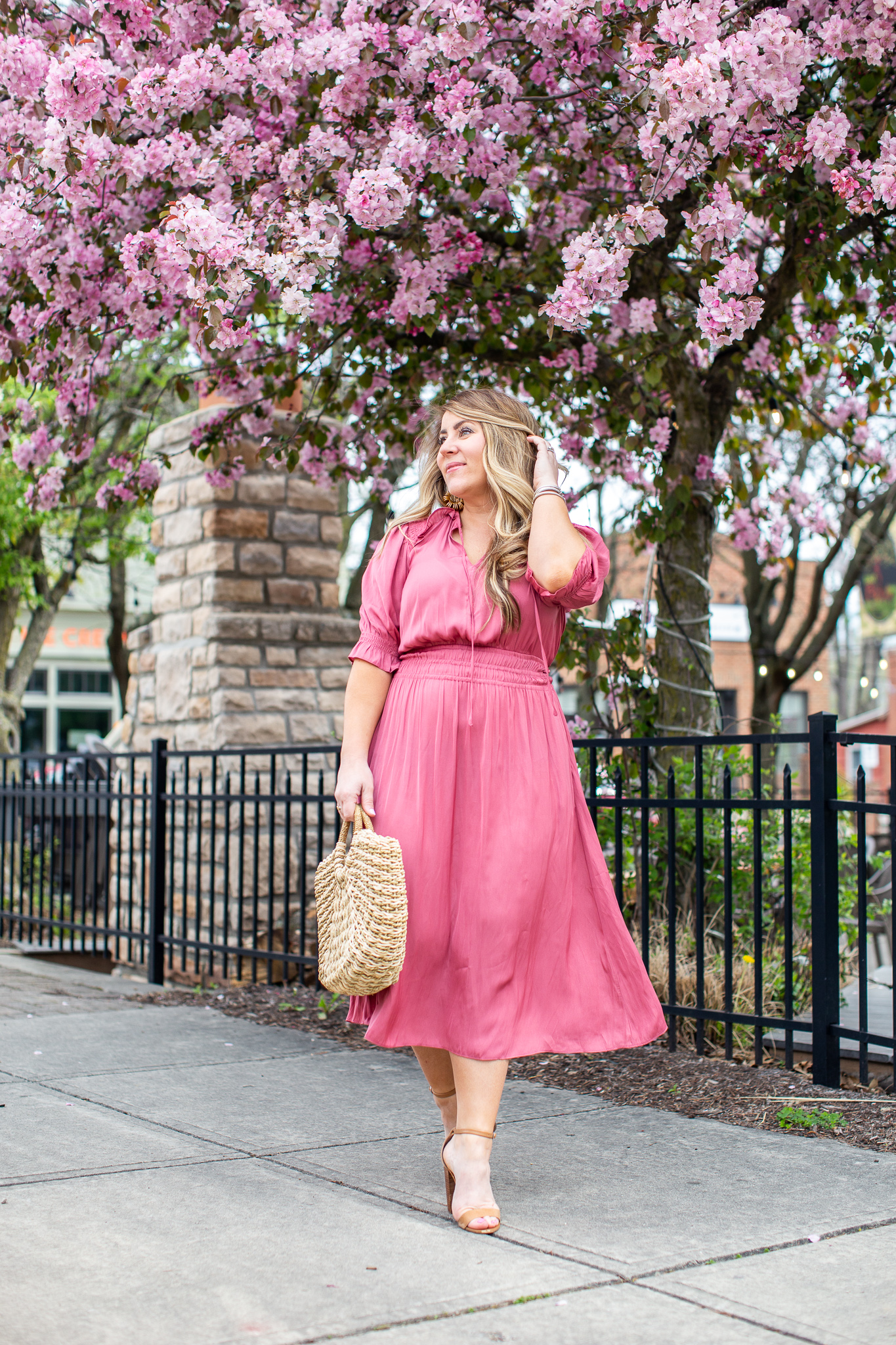 Pink Midi Dress featured by top US fashion blog Coffee Beans and Bobby Pins; Image of  a woman wearing pink Anthropologie dress and nude heels.