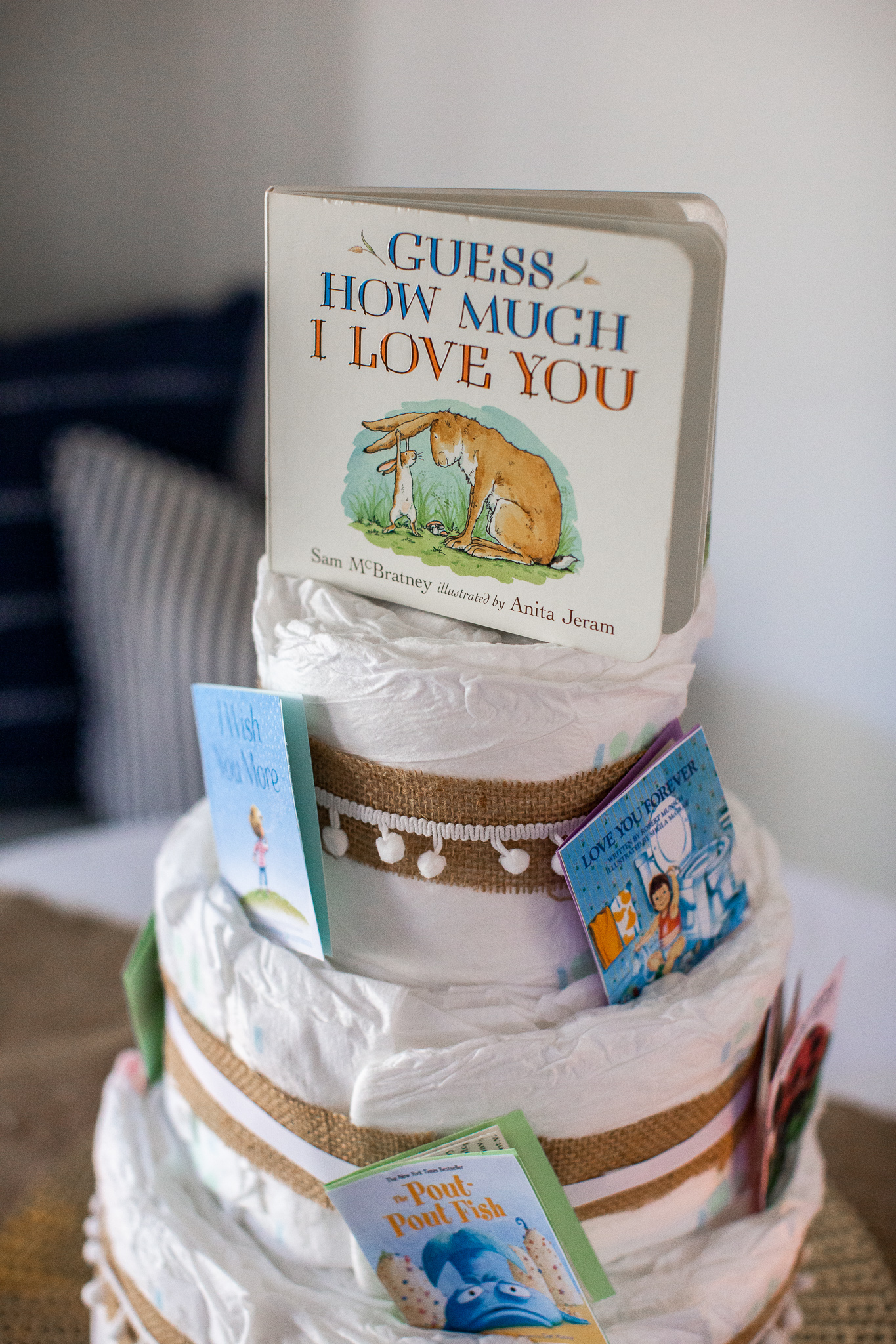  Story Book Baby Shower Ideas by popular North Carolina life and style blog, Coffee Beans and Bobby Pins: image of a diaper cake with children's picture books.