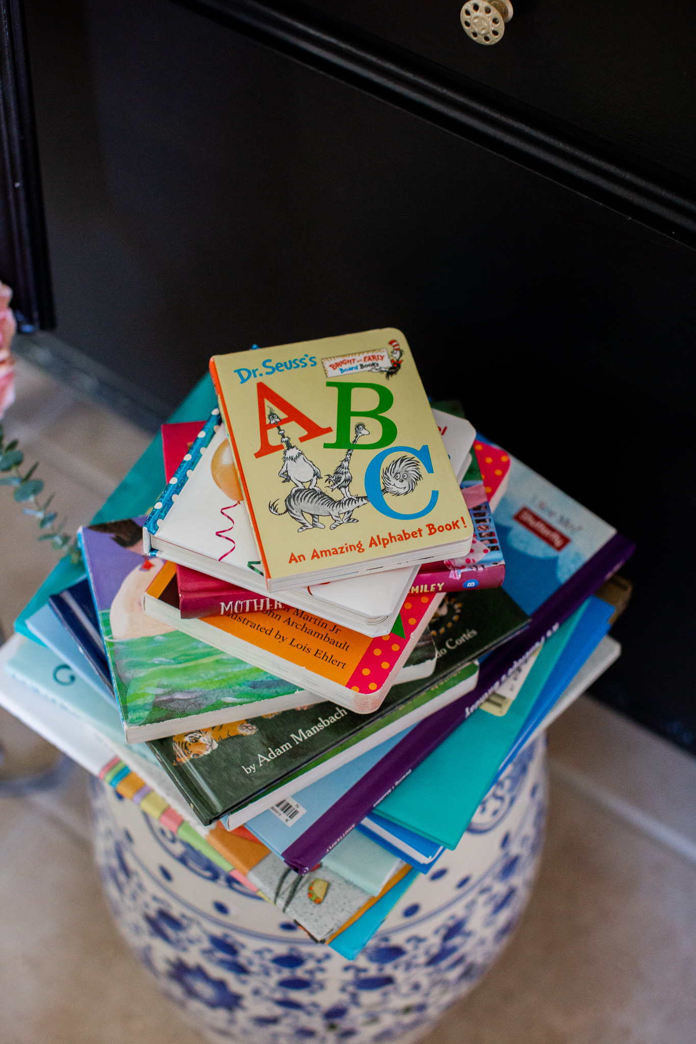  Story Book Baby Shower Ideas by popular North Carolina life and style blog, Coffee Beans and Bobby Pins: image of a pile of children's picture books.