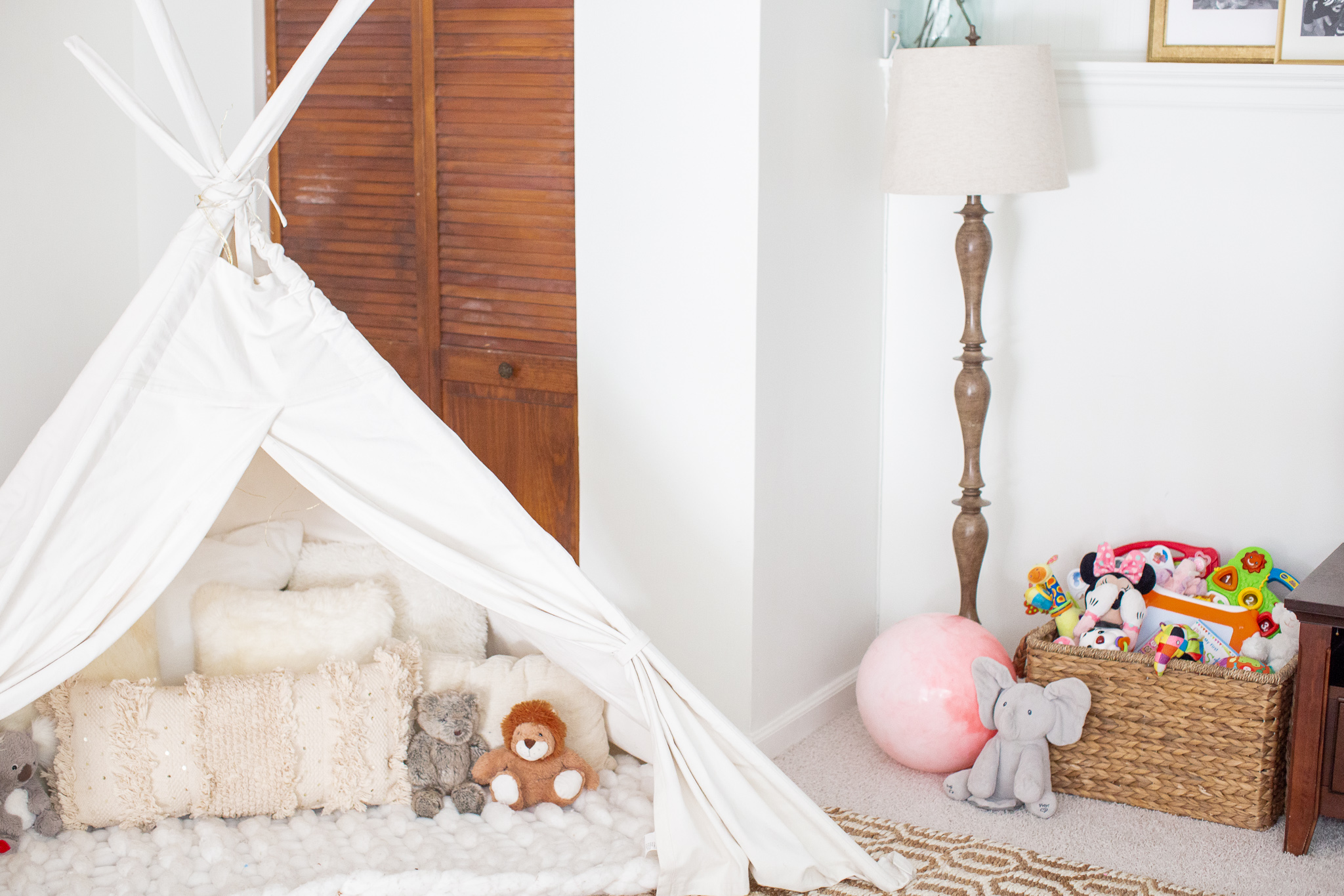 Playroom Storage Ideas and How I Combat All the Toys by popular North Carolina lifestyle blog, Coffee Beans and Bobby Pins: image of a playroom with a white tee-pee.