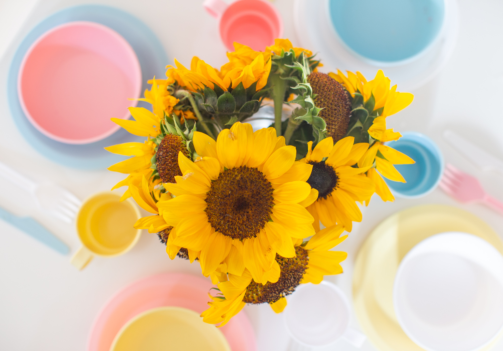 Playroom Storage Ideas and How I Combat All the Toys by popular North Carolina lifestyle blog, Coffee Beans and Bobby Pins: image of a vase of sunflowers in a playroom.