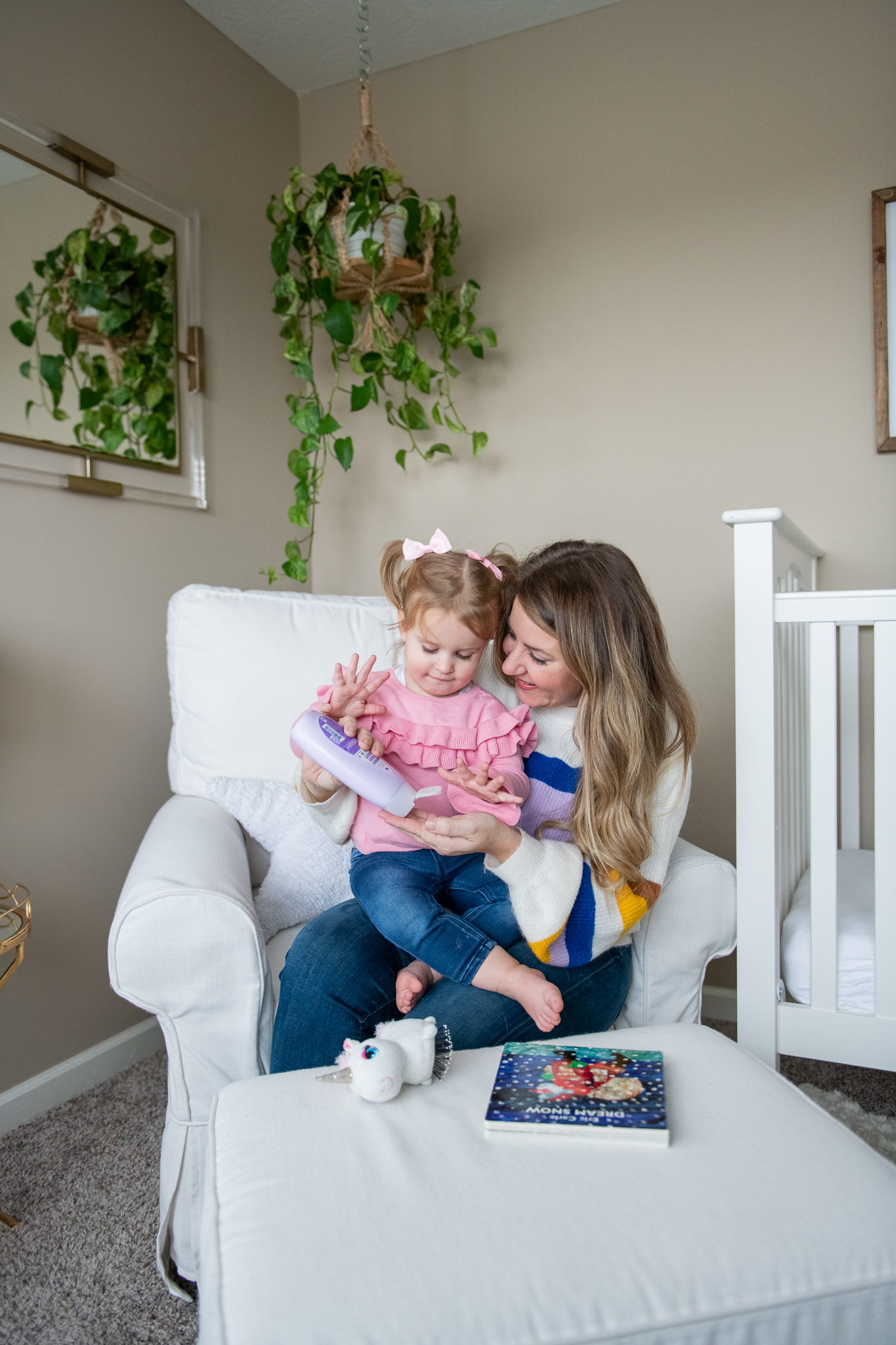 What's in Poppy's Medicine Cabinet by popular North Carolina life and style blog, Coffee Beans and Bobby Pins: image of a mom and daughter using Johnson & Johnson bedtime lotion. 