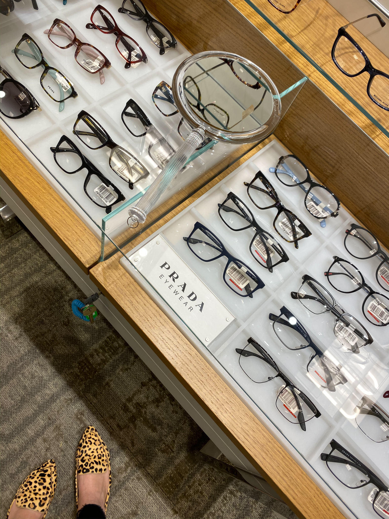 New Glasses with Lenscrafters at Macys by popular North Carolina life and style blog, Coffee Beans an Bobby Pins: image of glasses display case at Lenscrafters at Macys. 