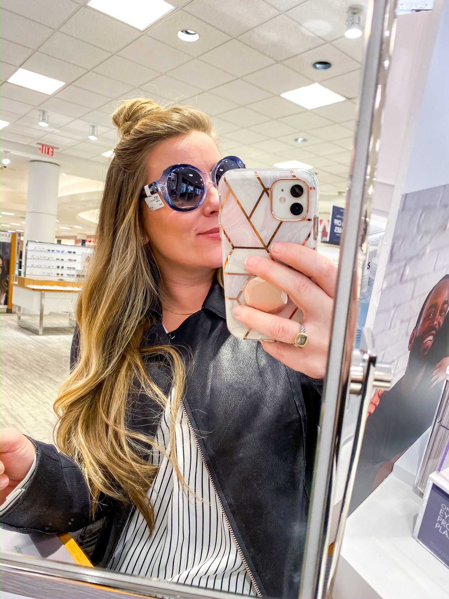 New Glasses with Lenscrafters at Macys by popular North Carolina life and style blog, Coffee Beans an Bobby Pins: image of a woman trying on sunglasses at Lenscrafters at Macys. 