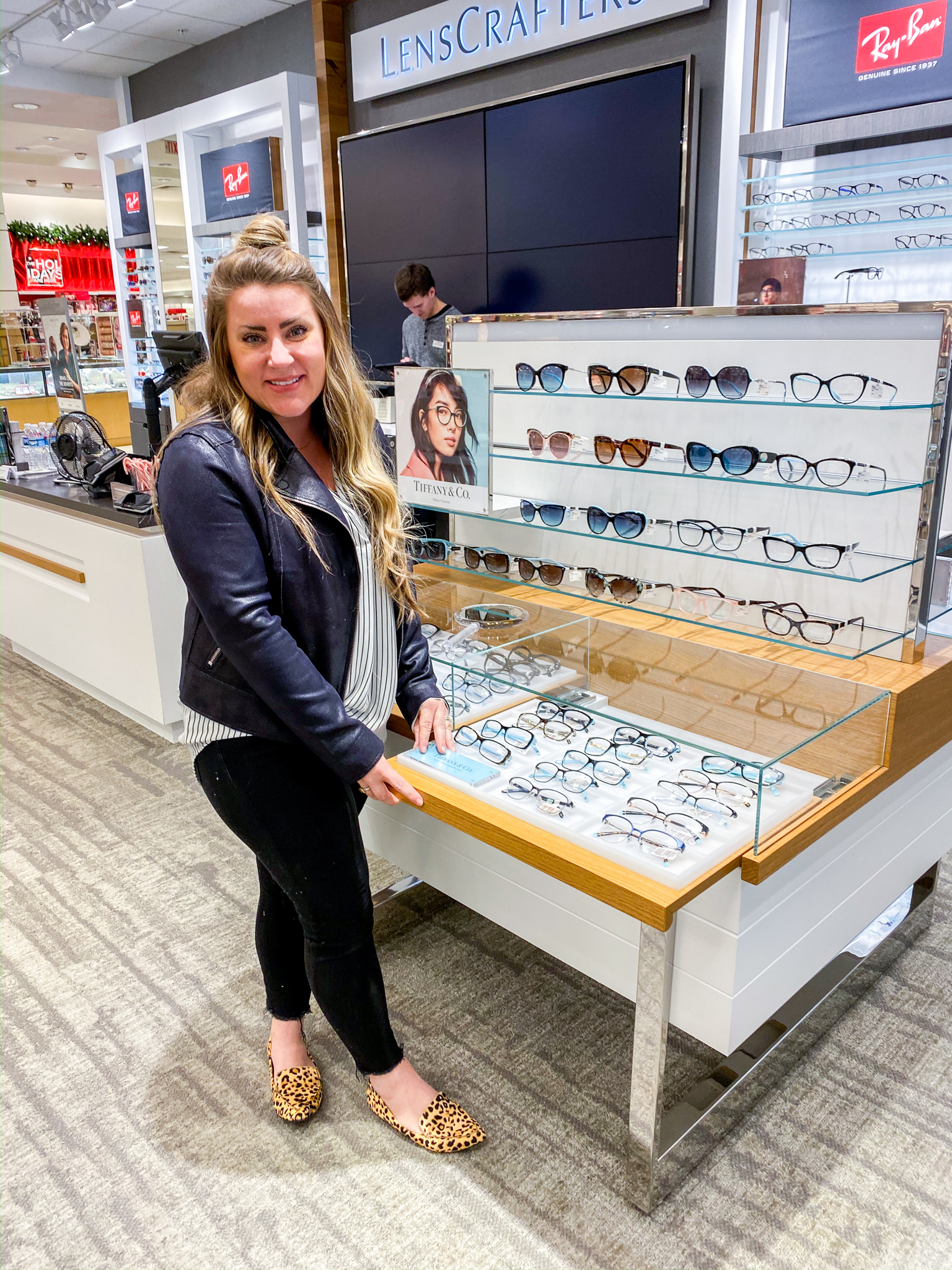 New Glasses with Lenscrafters at Macys by popular North Carolina life and style blog, Coffee Beans an Bobby Pins: image of a woman looking at glasses at Lenscrafters at Macys. 