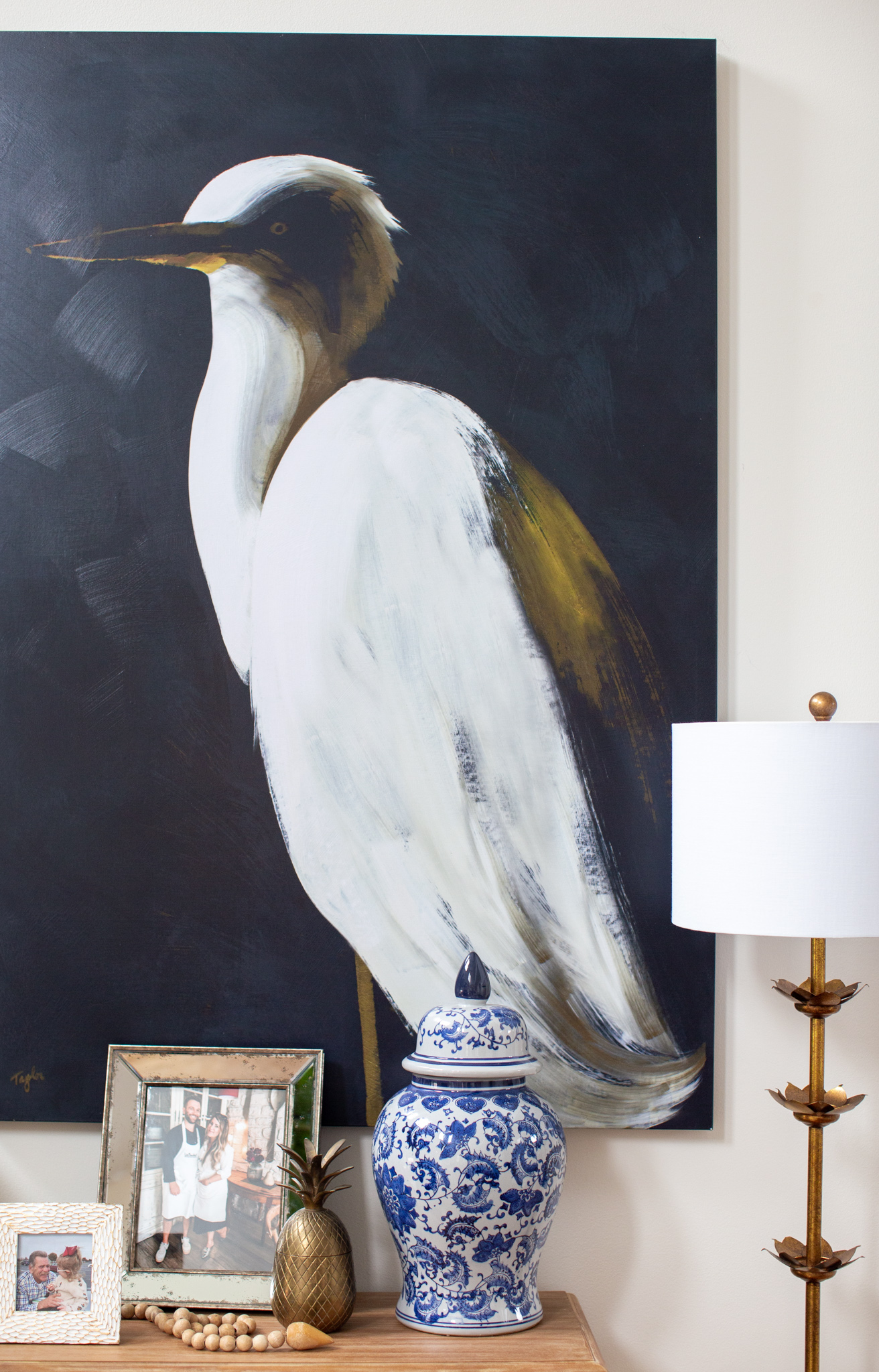 Grandin Road Wall Art by popular Ohio life and style blog, Coffee Beans and Bobby Pins: image of a living room decorated with Grandin Road White Heron Wall Art, Pottery Barn Tyler Upholstered Roll Arm Swivel Armchair, Etsy The Pillow Cover Store Fawn Pillow Cover, Wayfair Kempsford 64" Floor Lamp, The White Company Rectangular Seagrass Baskets, and World Market Everett Foyer Table.
