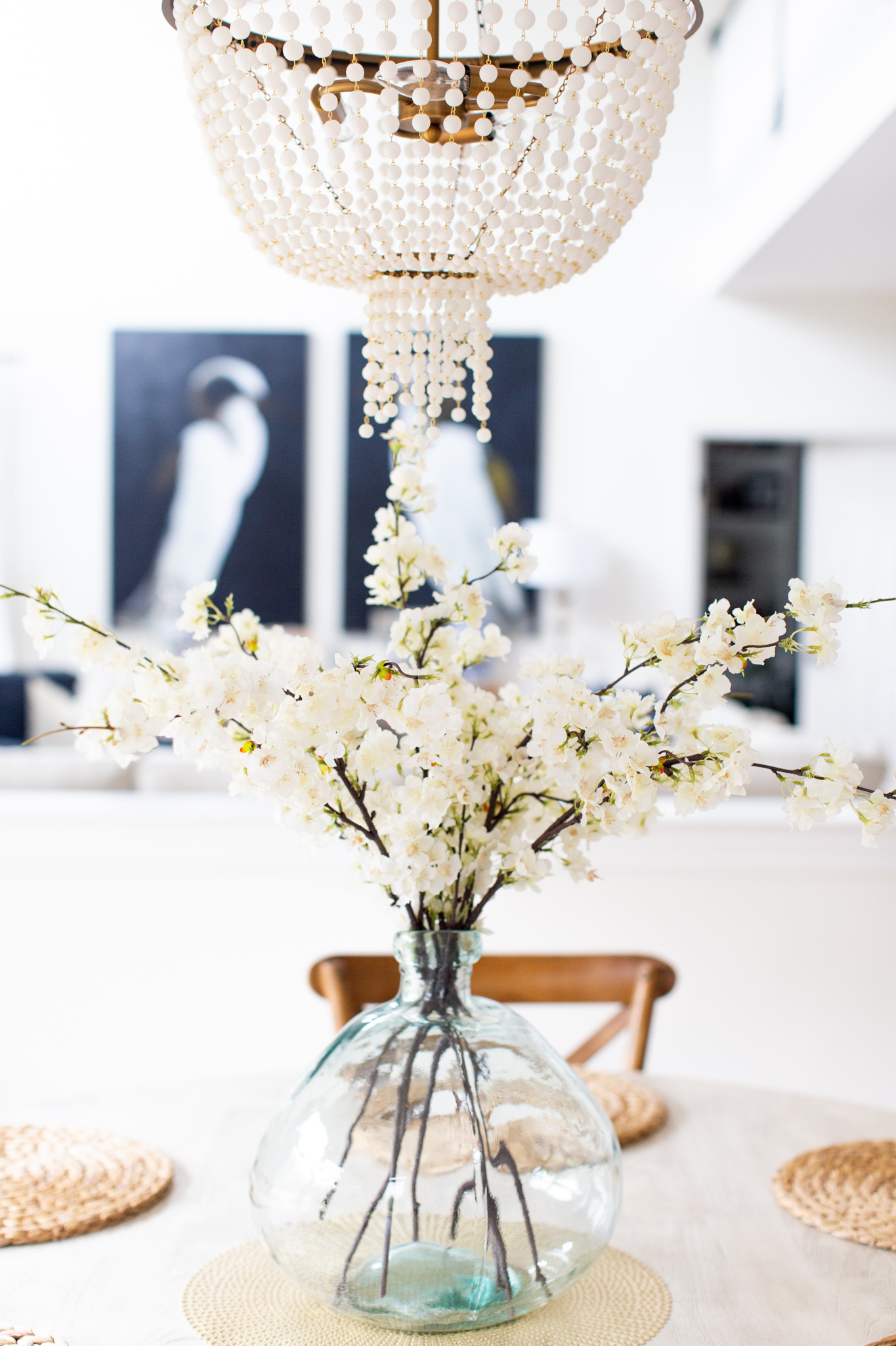 Self Quarantine Tips by popular Ohio lifestyle blog, Coffee Beans and Bobby Pins: image of a table containing a clear vase filled with faux white blossoms. 