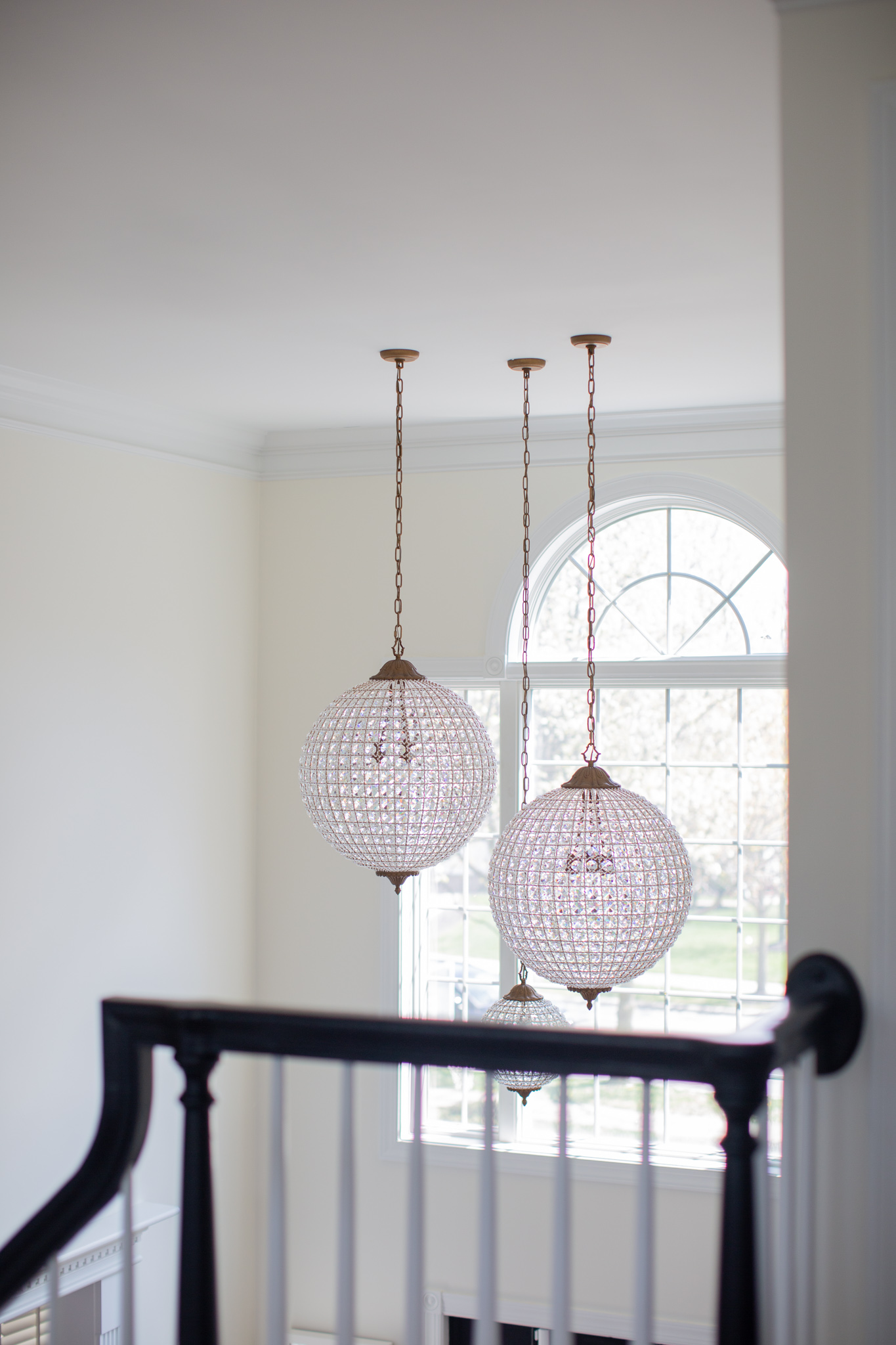 Arhaus Lighting by popular Ohio life and style blog, Coffee Beans and Bobby Pins: image of a entry way decorated with a Arhaus poppy large chandelier.