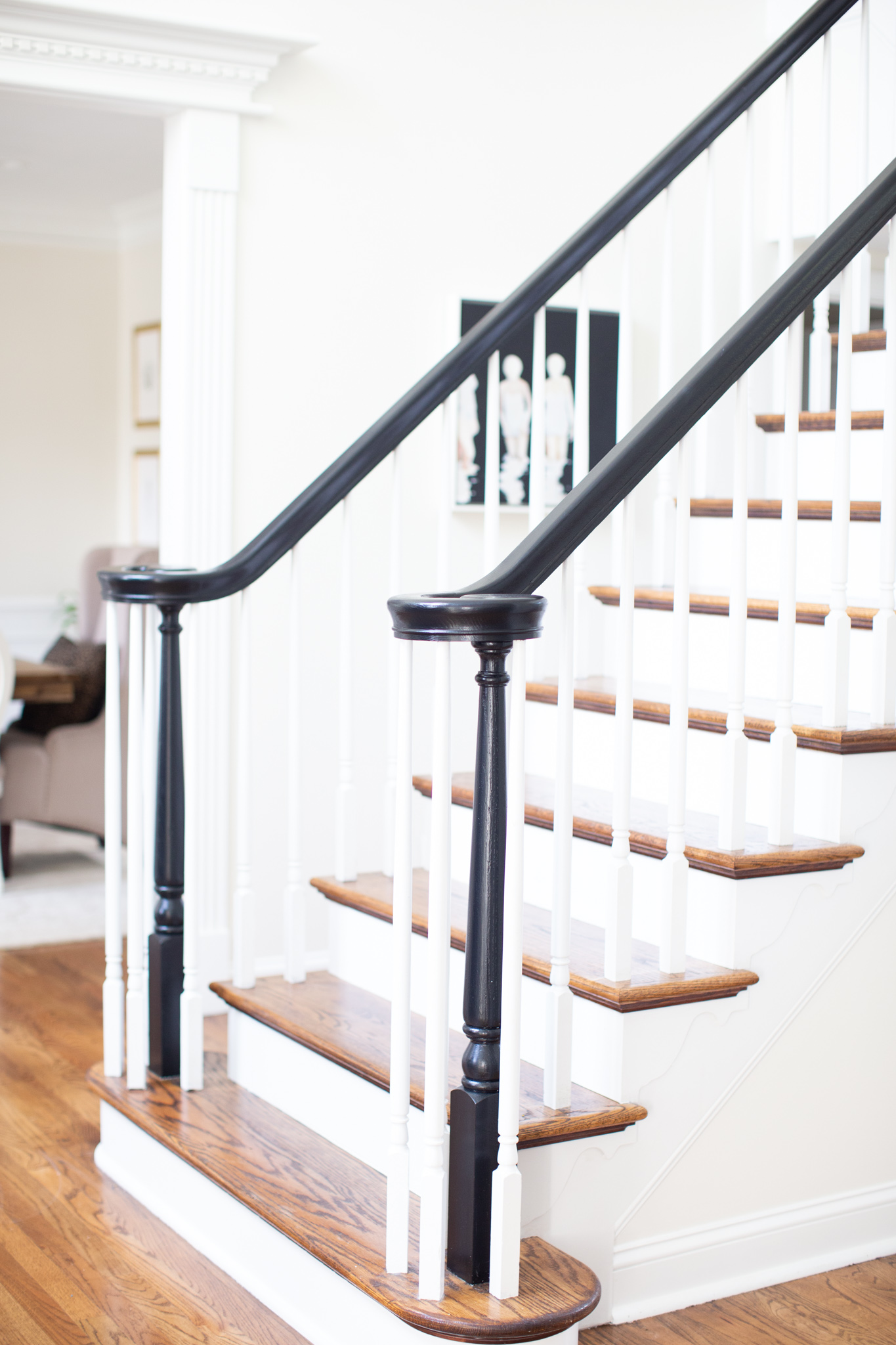 DIY Stair Railing Makeover by popular Ohio DIY blog, Coffee Beans and Bobby Pins: image of a black and white banister. 