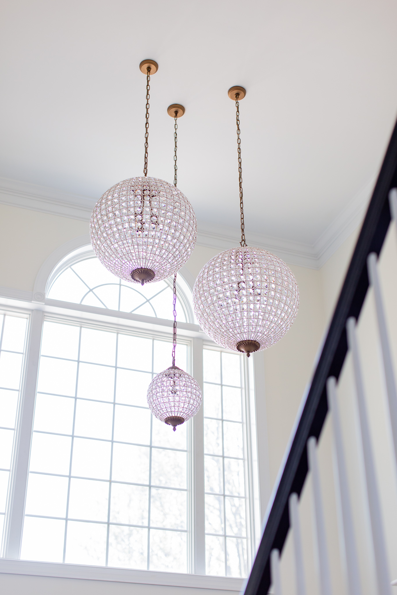 Arhaus Lighting by popular Ohio life and style blog, Coffee Beans and Bobby Pins: image of a entry way decorated with a Arhaus poppy large chandelier.