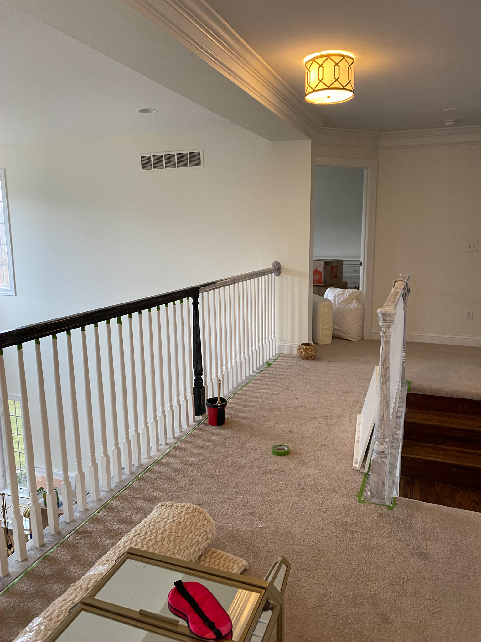 DIY Stair Railing Makeover by popular Ohio DIY blog, Coffee Beans and Bobby Pins: image of a banister being painted black. 