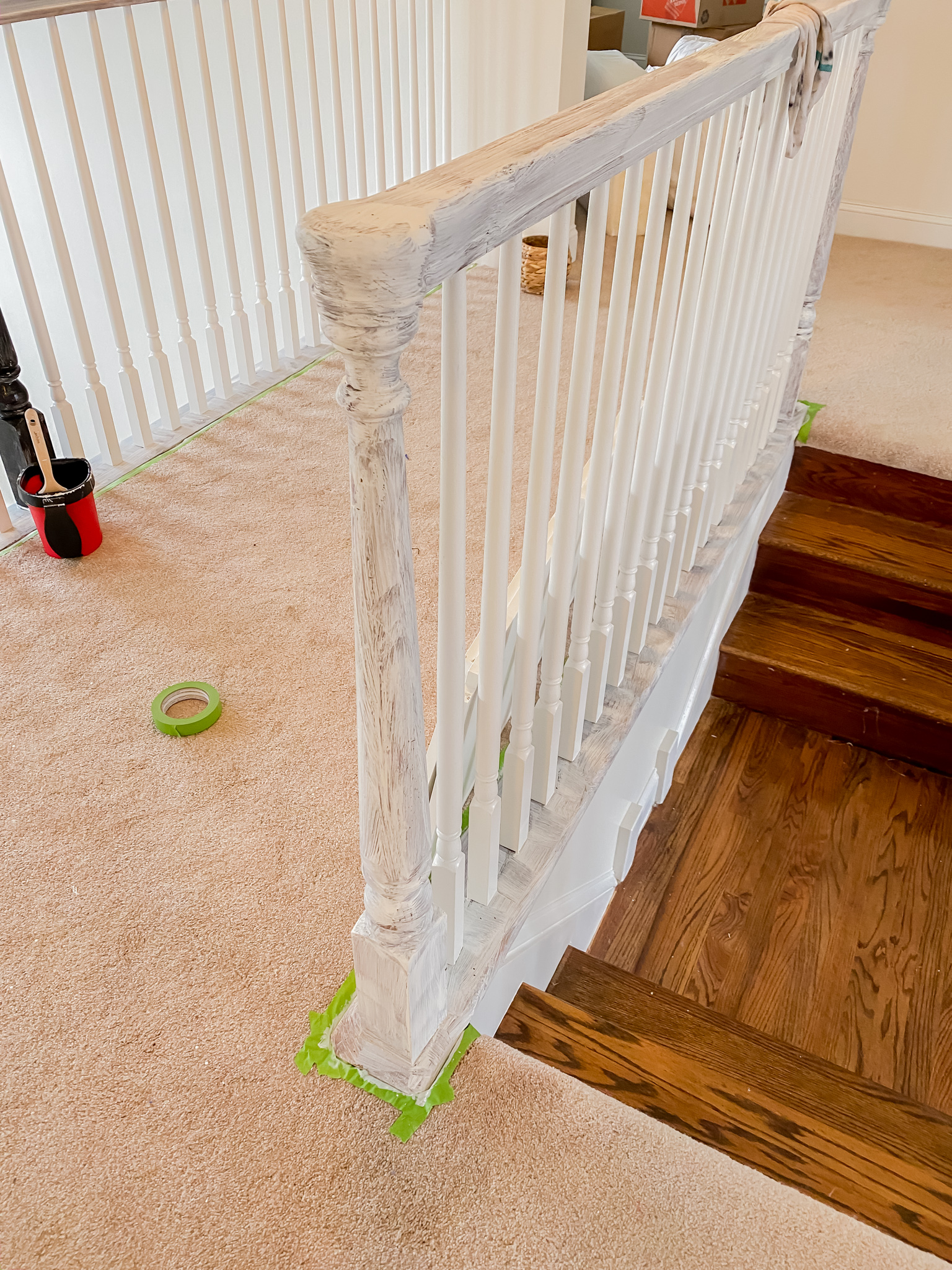 DIY Stair Railing Makeover by popular Ohio DIY blog, Coffee Beans and Bobby Pins: image of a banister covered in white primer paint. 