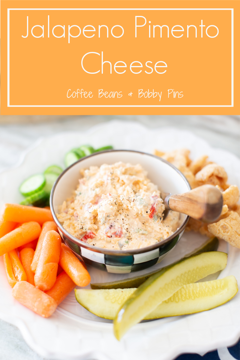 Jalapeno Pimento Cheese by popular Ohio food blog, Coffee Beans and Bobby Pins: Pinterest image of a white plate with a bowl of jalapeno pimento cheese, baby carrots, English cucumber slices, pickle spears, and chips. 