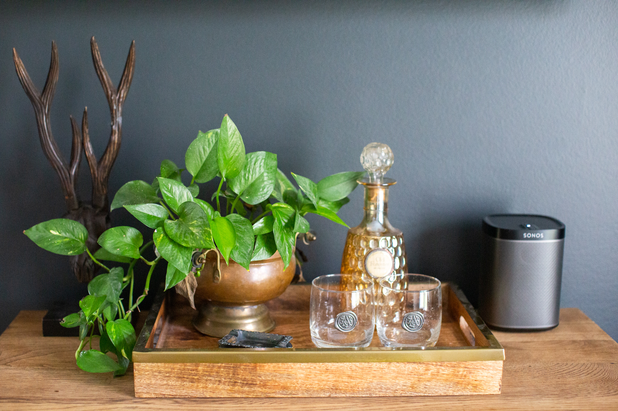 Mixing Old and New Furniture by popular Ohio life and style blog, Coffee Beans and Bobby Pins: image of a wood tray with a vintage decanter, monogramed glasses, and vintage plant pot. 