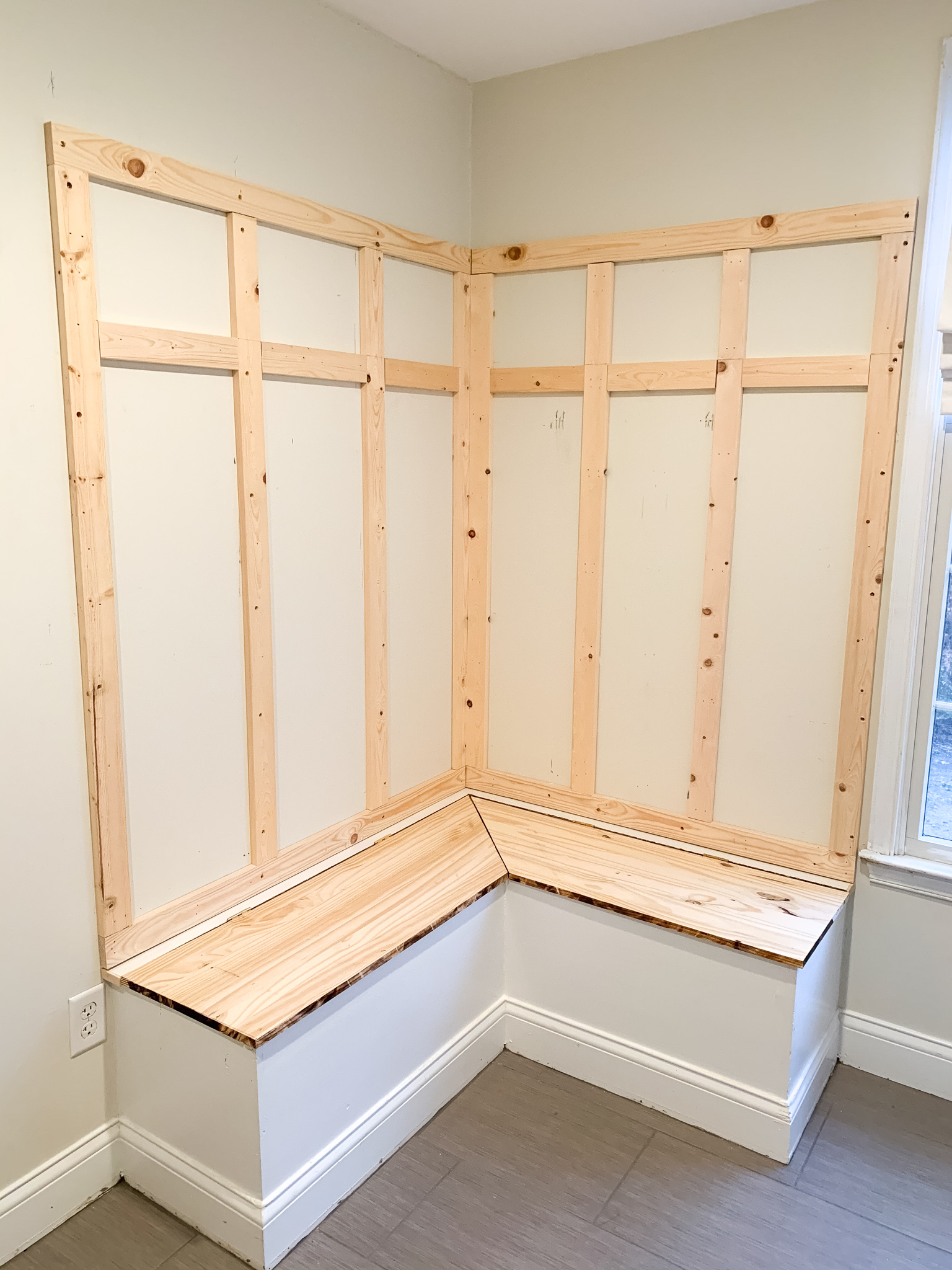 One Room Challenge by popular life and style blog, Coffee Beans and Bobby Pins: image of mudroom bench with horizontal pieces of wood nailed into the wall above it. 
