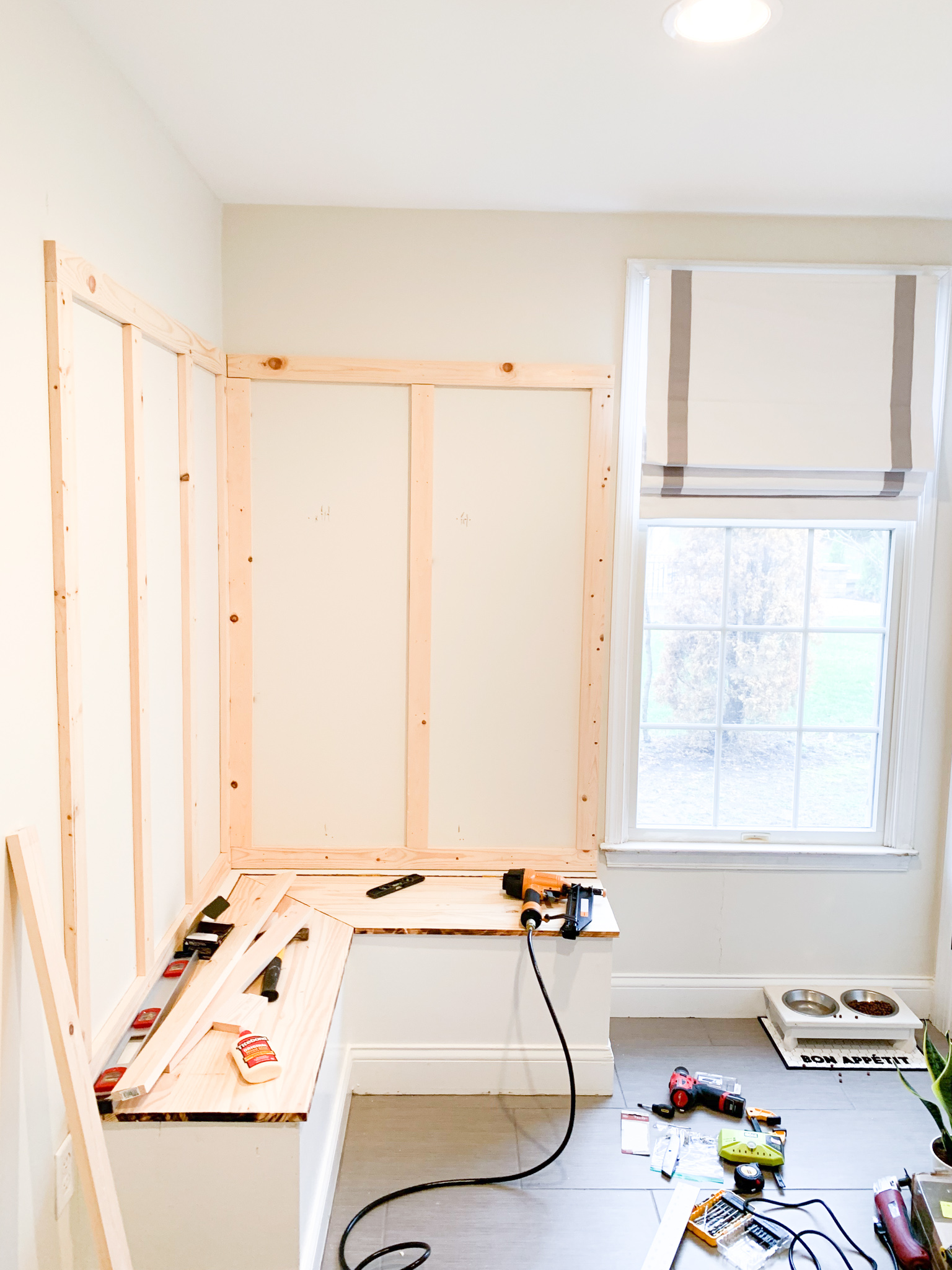 One Room Challenge by popular life and style blog, Coffee Beans and Bobby Pins: image of mudroom filled with various work tools and a partially built work bench. 