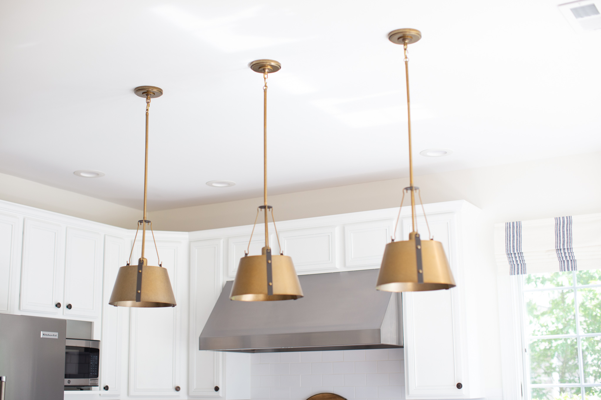 Build.com Lighting by popular Ohio life and style blog, Coffee Beans and Bobby Pins: image of a kitchen with Build.com Hinkley Lighting Cartwright Single Light 15-1/4" Wide Pendant handing over a kitchen island. 