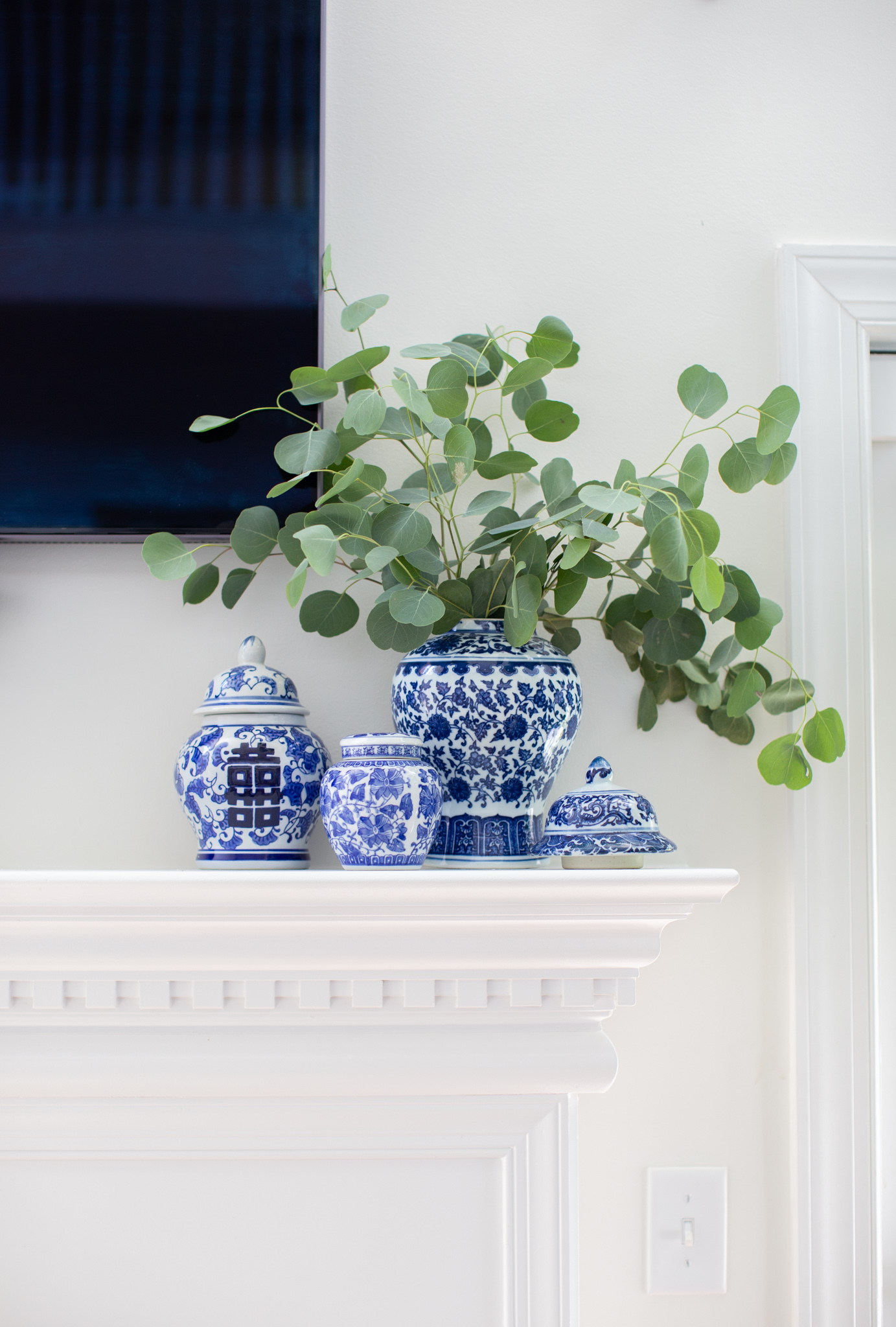Living Room Furniture by popular Ohio life and style blog, Coffee Beans and Bobby Pins: image of a white fireplace mantle displaying some blue and white porcelain pieces. 