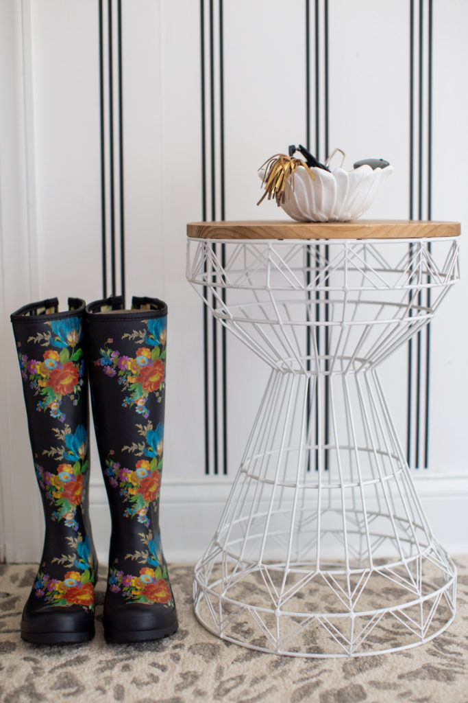 Mudroom Decor by popular Ohio life and style blog, Coffee Beans and Bobby Pins: image of a mudroom decorated with Livette's Wallpaper MINIMAL STRIPES REMOVABLE WALLPAPER, Rugs USA Gray Leopard Print Area Rug, white wood frame white boards and floral print rain boots. 