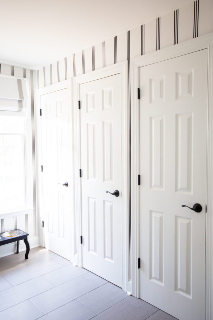Mudroom Decor by popular Ohio life and style blog, Coffee Beans and Bobby Pins: image of a mudroom decorated with Livette's Wallpaper MINIMAL STRIPES REMOVABLE WALLPAPER.