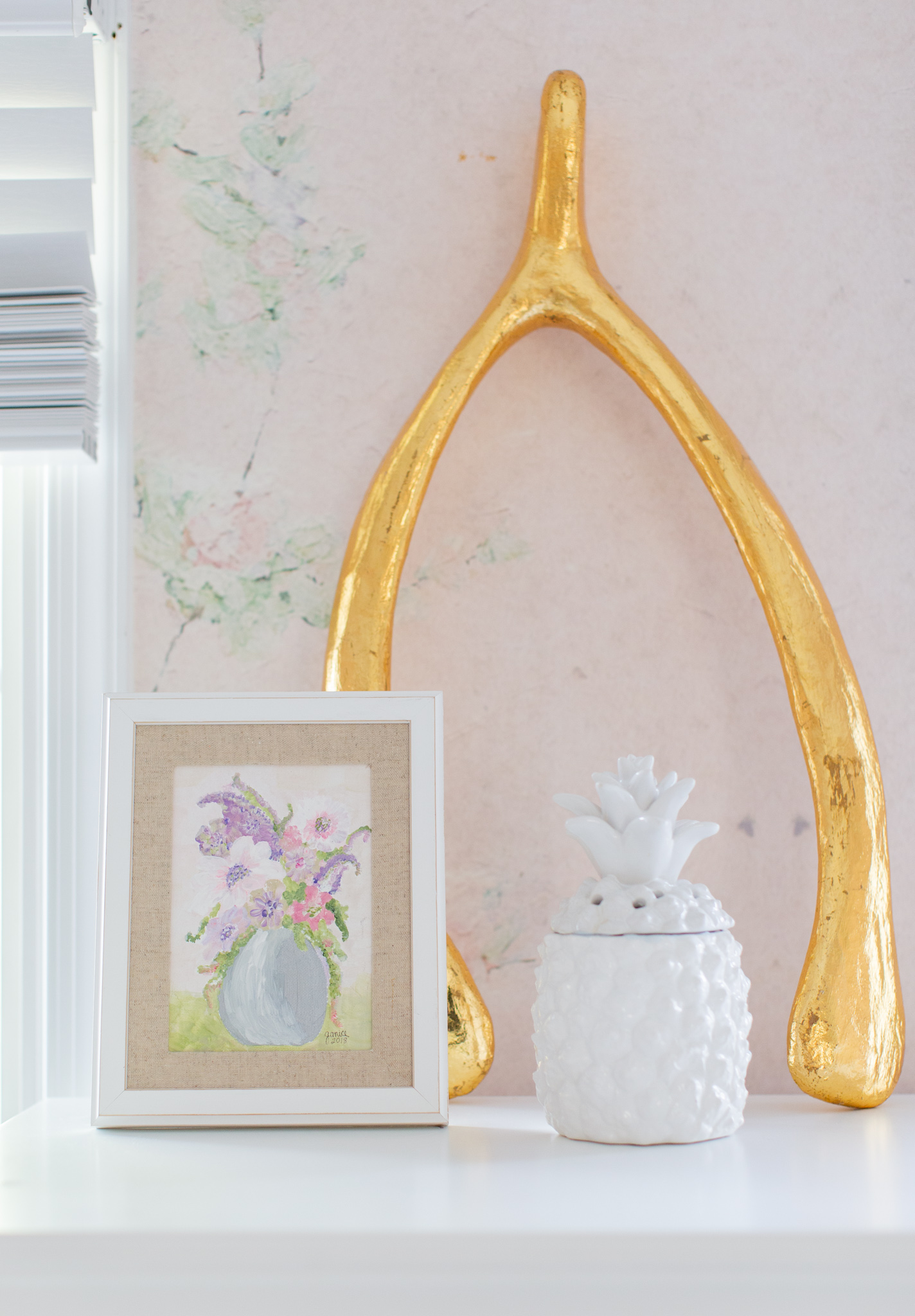 Floral Nursery by popular Ohio life and style blog, Coffee Beans and Bobby Pins: image of a nursery with Anewall Sweet Laurel Mural wallpaper and a gold wishbone decor item. 