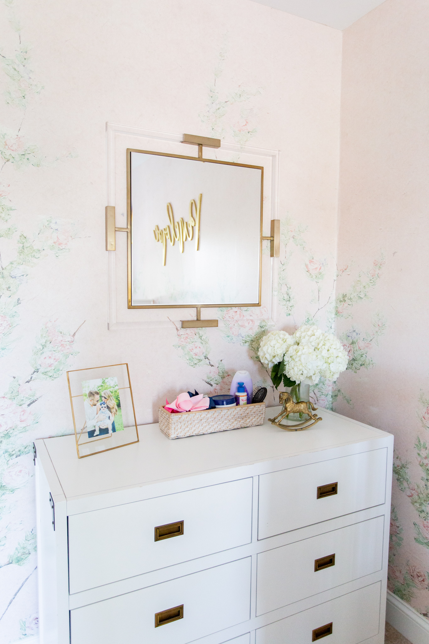 Floral Nursery by popular Ohio life and style blog, Coffee Beans and Bobby Pins: image of a nursery with Anewall Sweet Laurel Mural wallpaper and a white dresser. 
