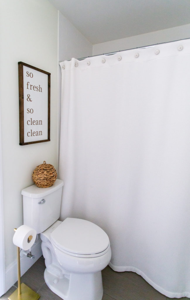 Jack n Jill Bathroom by popular Ohio life and style blog, Coffee Beans and Bobby Pins: image of a Jack n Jill bathroom decorated with a Etsy Peachie and Tink So Fresh & So Clean Clean Sign, Pottery Barn Waffle Weave Shower Curtain.