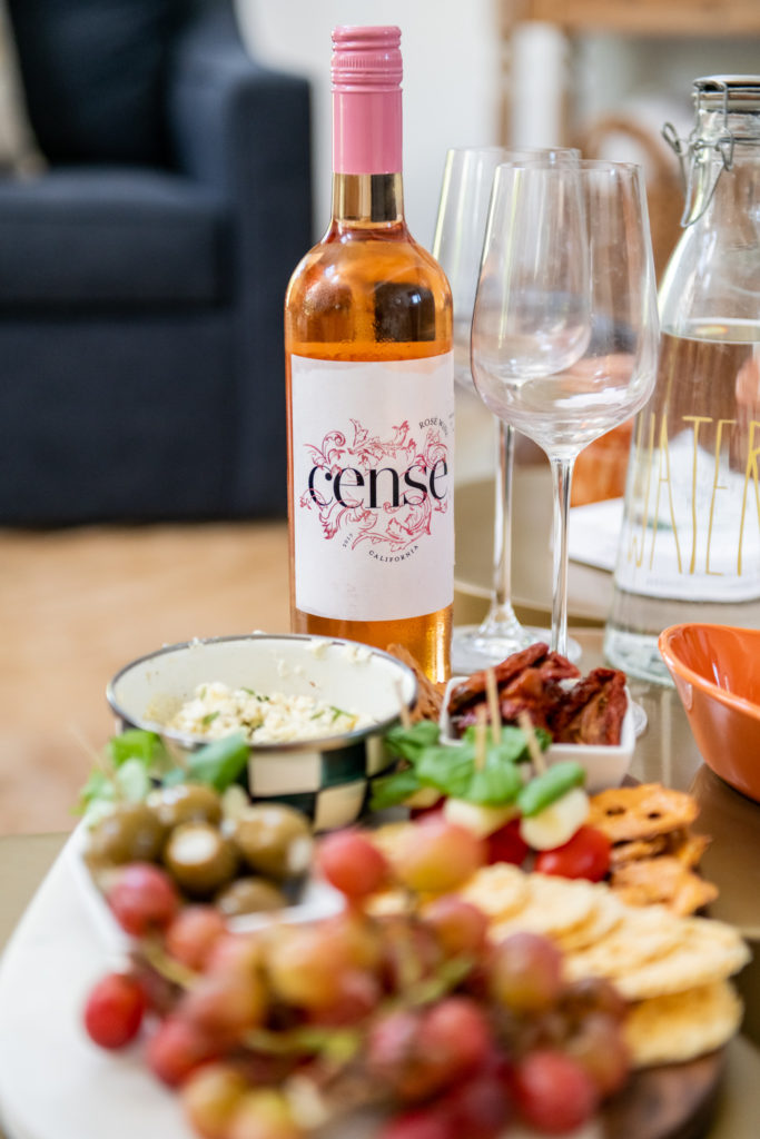 Snack Board by popular Ohio food blog, Coffee Beans and Bobby Pins: image of a snack board and a bottle of Cense wine. 