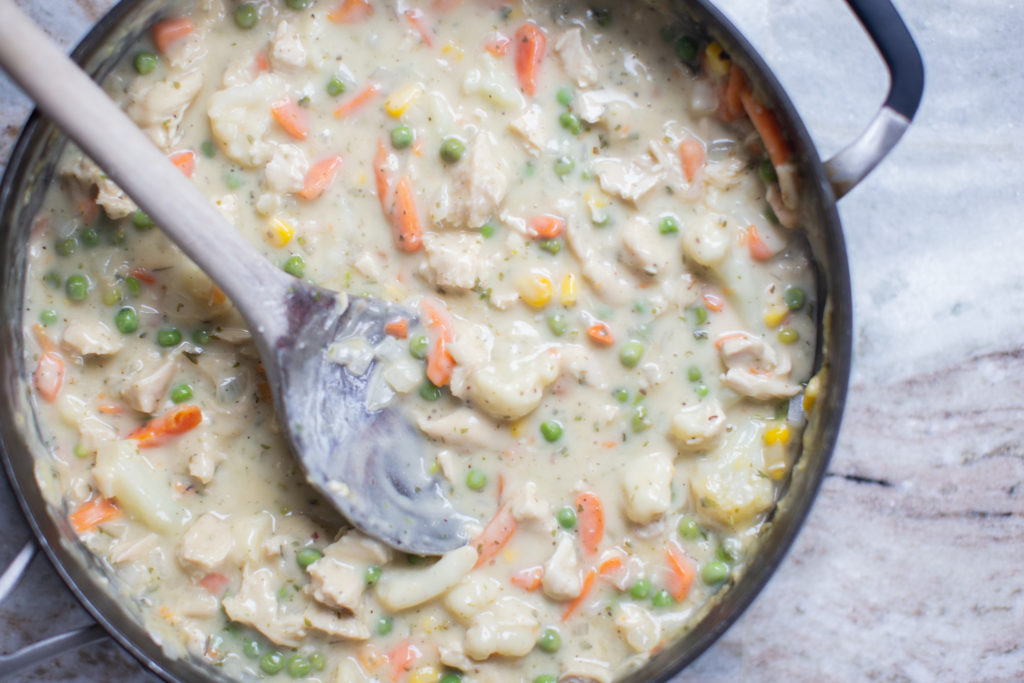 Homemade Chicken Pot Pie by popular Ohio lifestyle blog, Coffee Beans and Bobby Pins: image of homemade chicken pot pie filling in a skillet. 