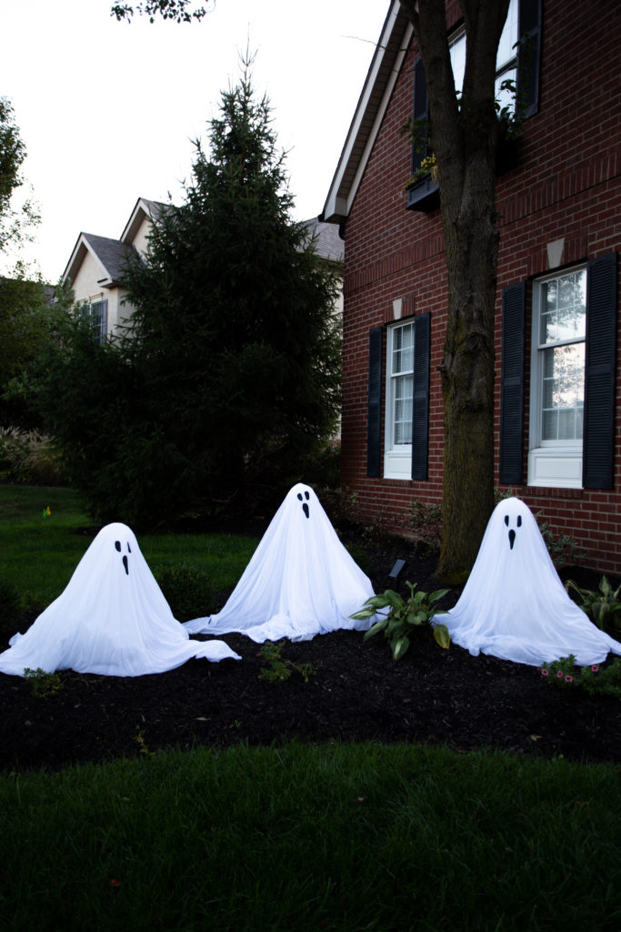 Halloween Front Porch by popular Ohio life and style blog, Coffee Beans and Bobby Pins: image of ghost yard decorations. 