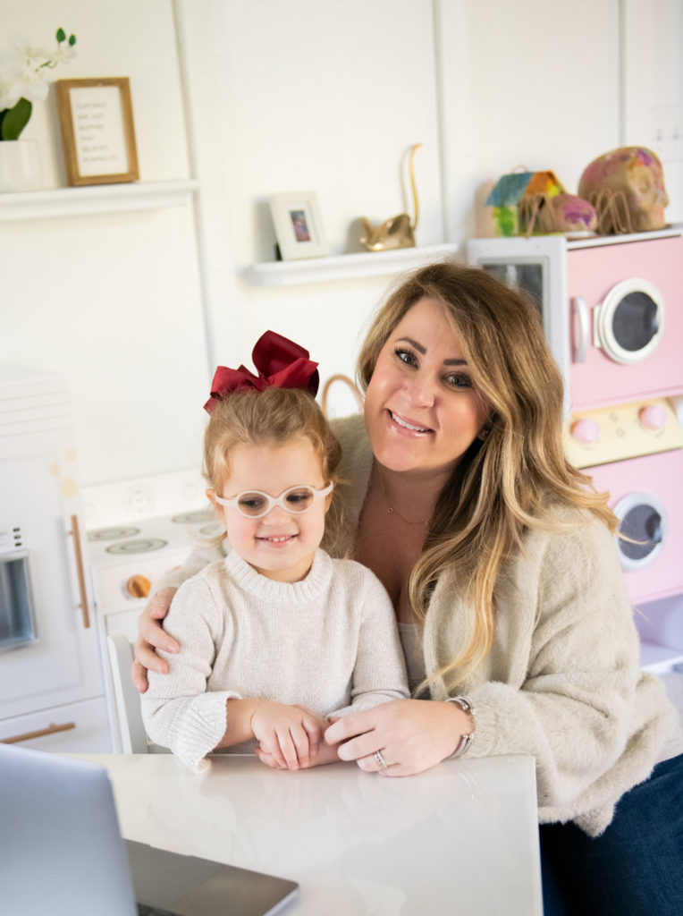 Talk to Santa by popular Ohio lifestyle blog, Coffee Beans and Bobby Pins: image of a mom and her young daughter sitting together in a playroom in front of an open laptop. 