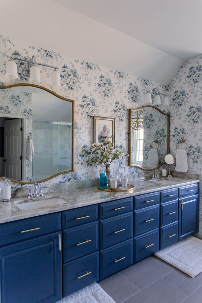 Master Bedroom Remodel by popular Ohio life and style blog, Coffee Beans and Bobby Pins: image of master bathroom with blue and white floral wallpaper, blue vanity and gold frame mirrors. 