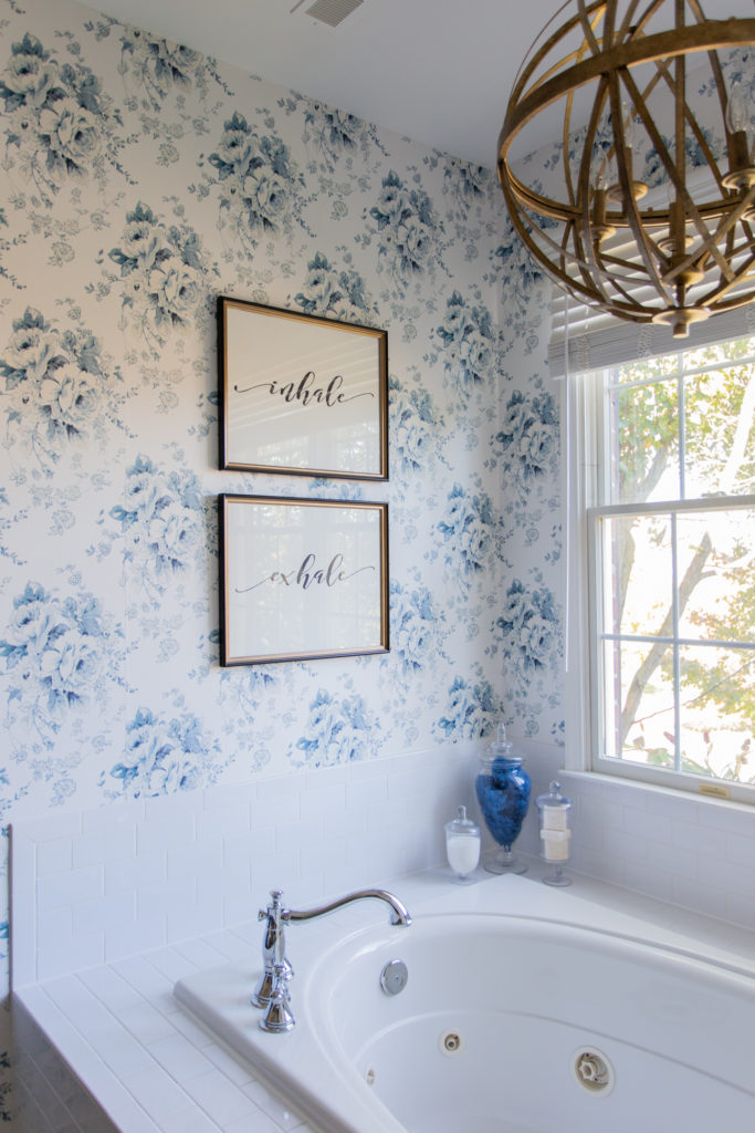 Master Bedroom Remodel by popular Ohio life and style blog, Coffee Beans and Bobby Pins: image of master bathroom with blue and white floral wallpaper, gold light fixture, and jetted tub. 