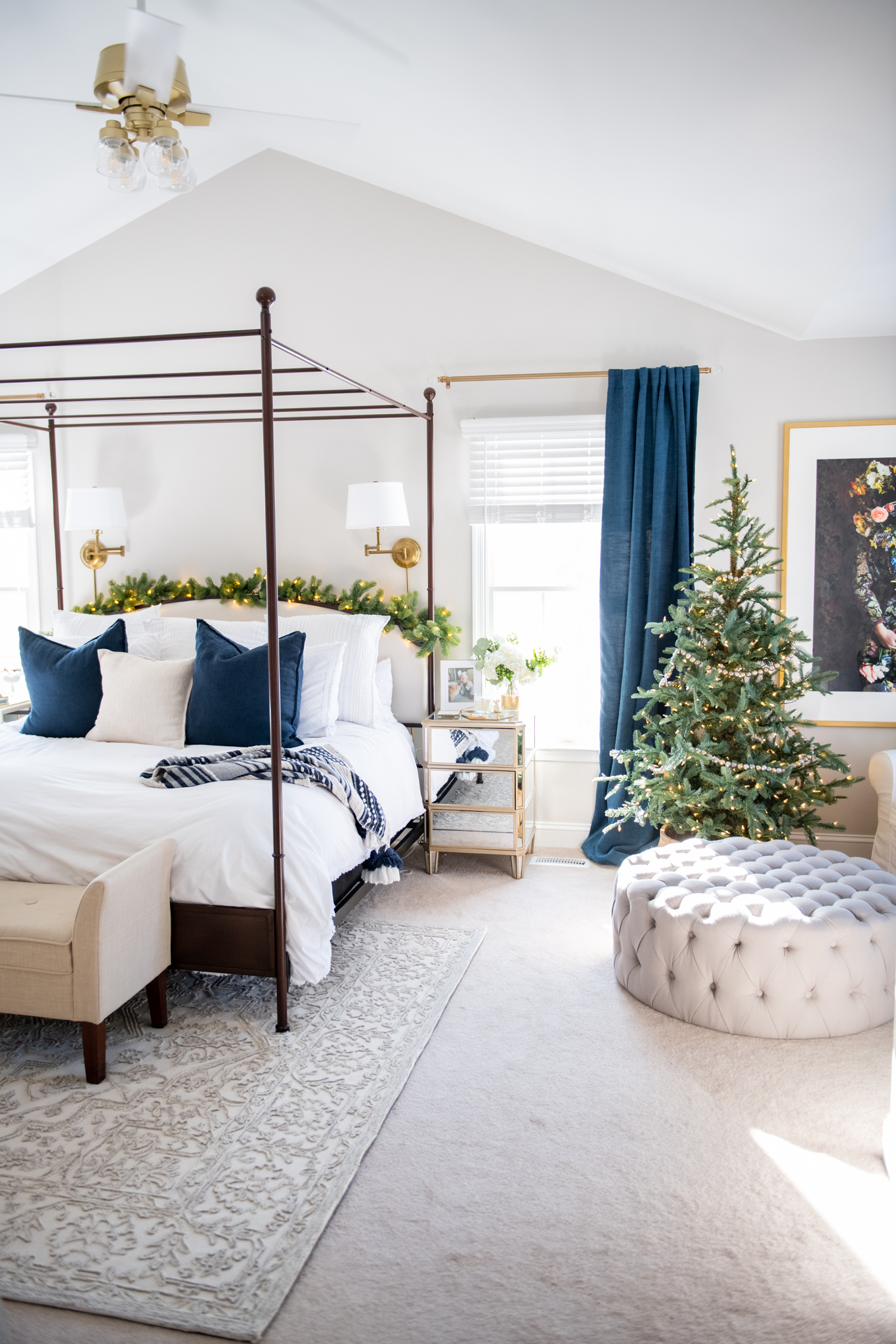 Holiday Decor by popular Ohio life and style blog, Coffee Beans and Bobby Pins: image of a master bedroom decorated with a faux garland and faux Christmas tree. 