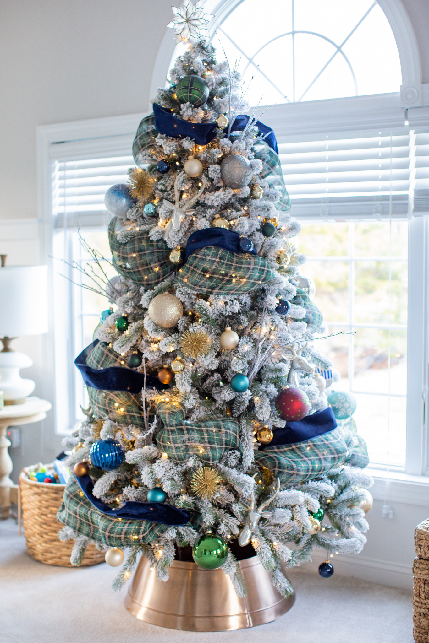 Christmas Home Tour by popular Ohio life and style blog, Coffee Beans and Bobby Pins: image of a blue, green, and gold flocked Christmas tree. 