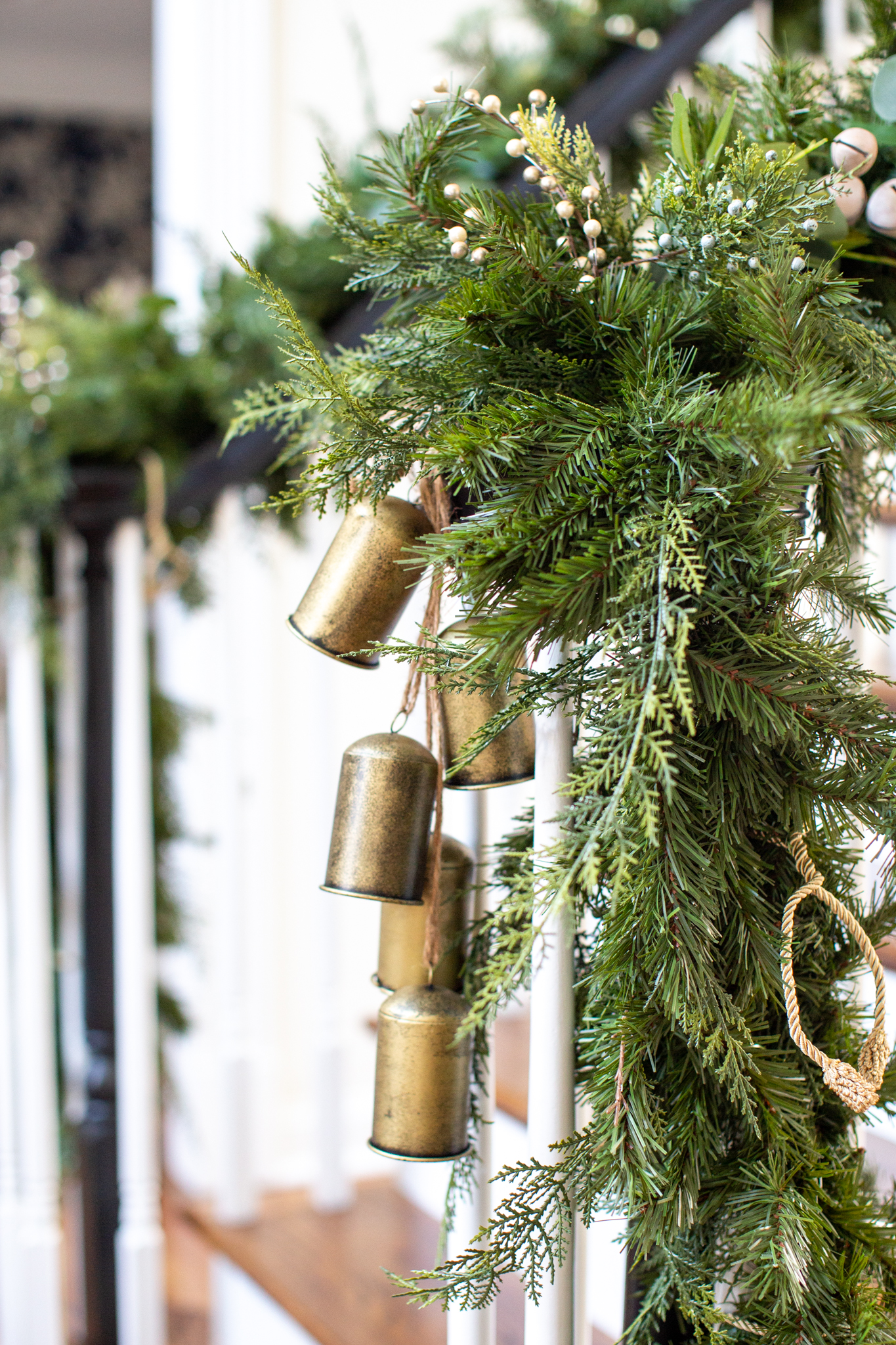 Christmas Home Tour by popular Ohio life and style blog, Coffee Beans and Bobby Pins: image of a Grandin Road garland and brass bells. 