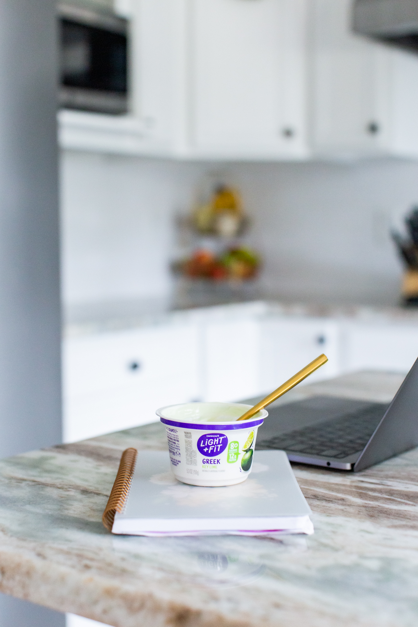 Making Goals by popular Ohio lifestyle blog, Coffee Beans and Bobby Pins: image of Danon Light + Fit Greek yogurt cup with a gold spoon in it. 