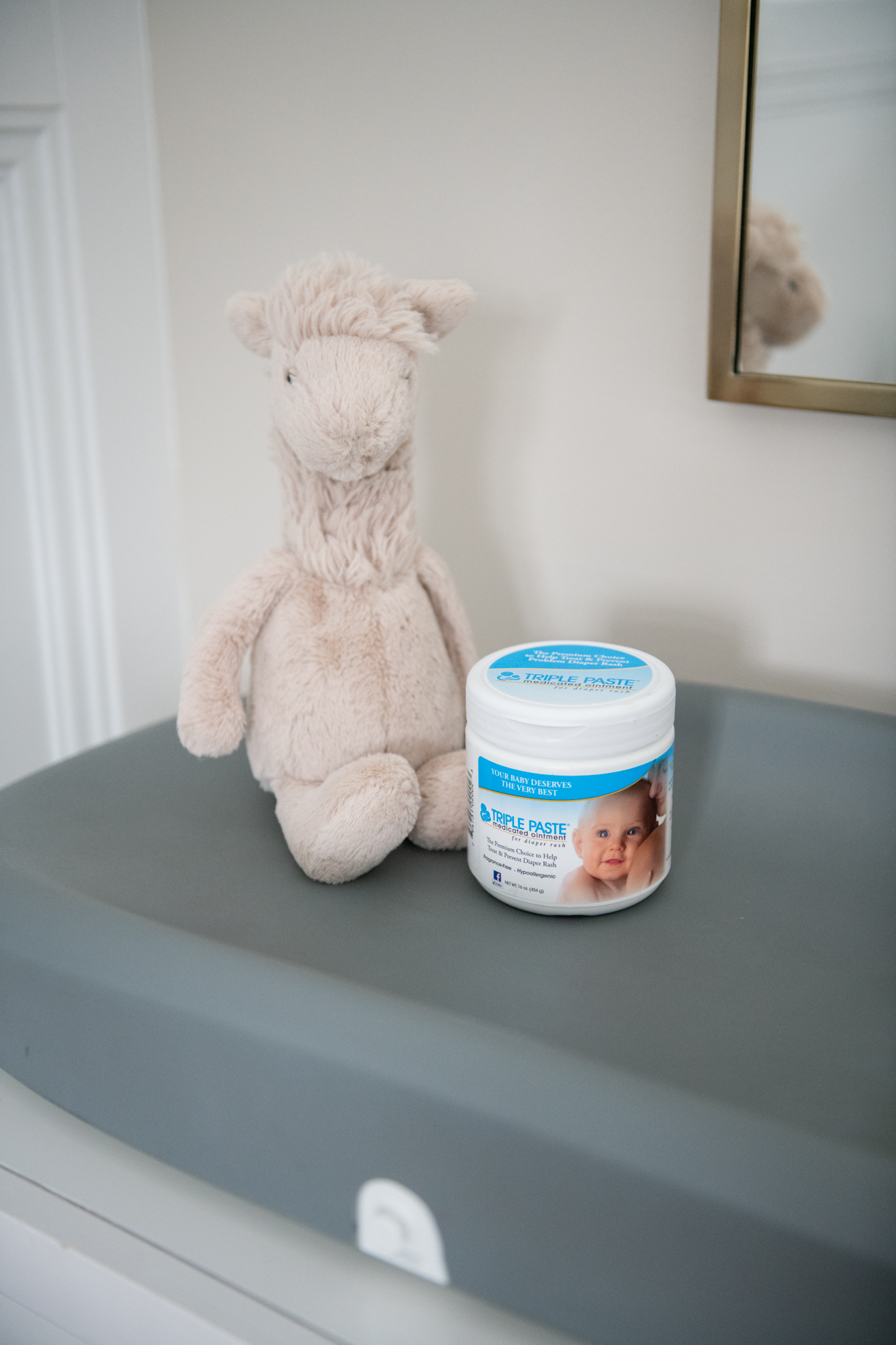 Diaper Rash Remedies by popular Ohio motherhood blog, Coffee Beans and Bobby Pins: image of a stuffed llama and Triple Paste medical ointment. 